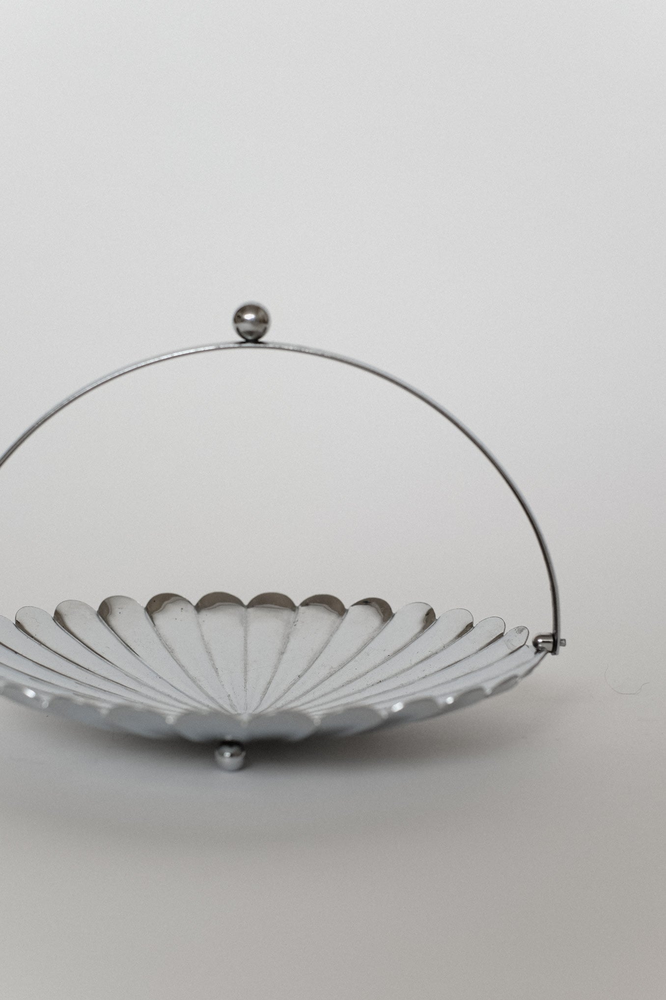 Serving Dish With Handle — side view of silver metal dish
