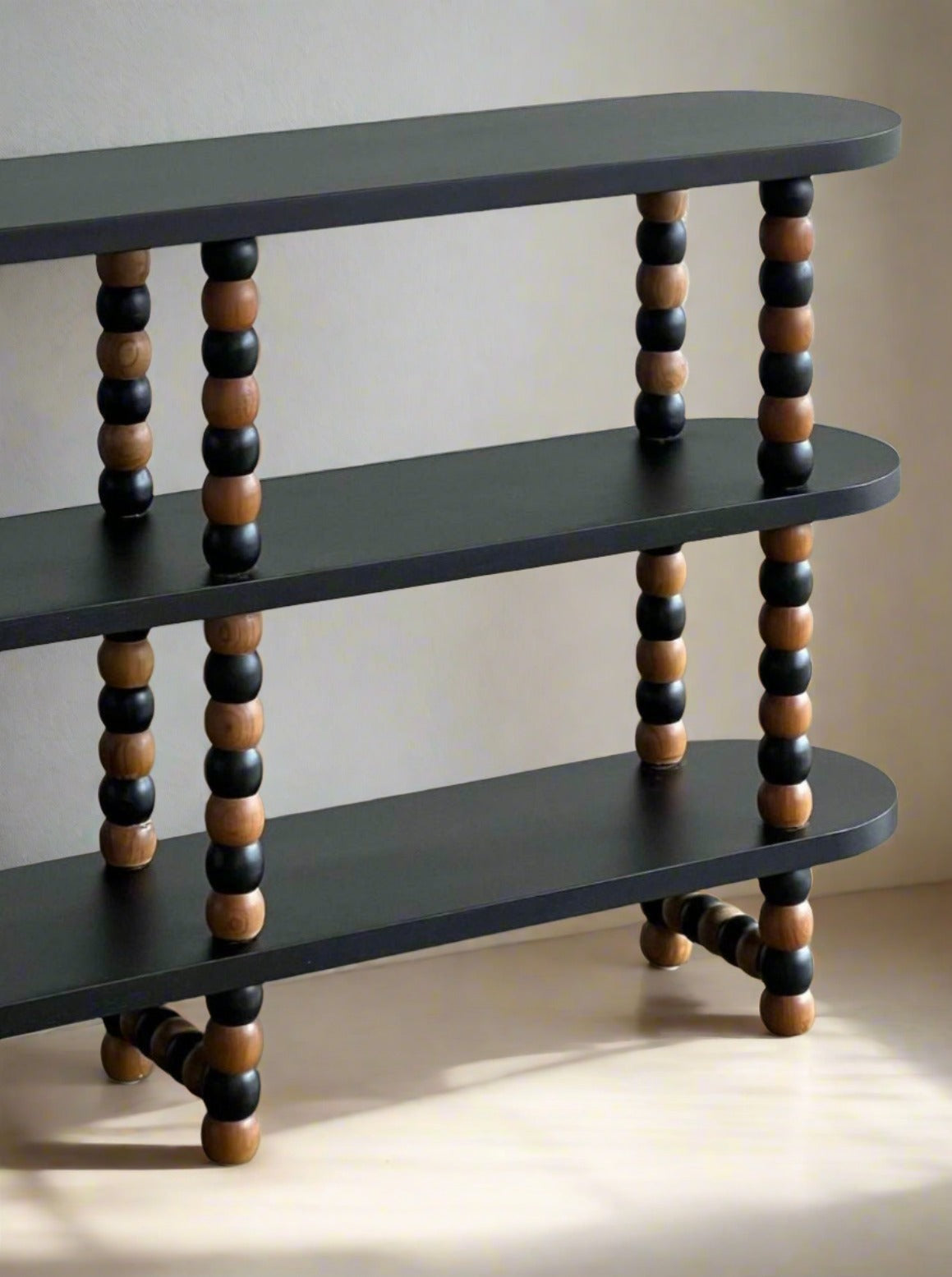 Onde Shelf — close-up of black and wood round legs