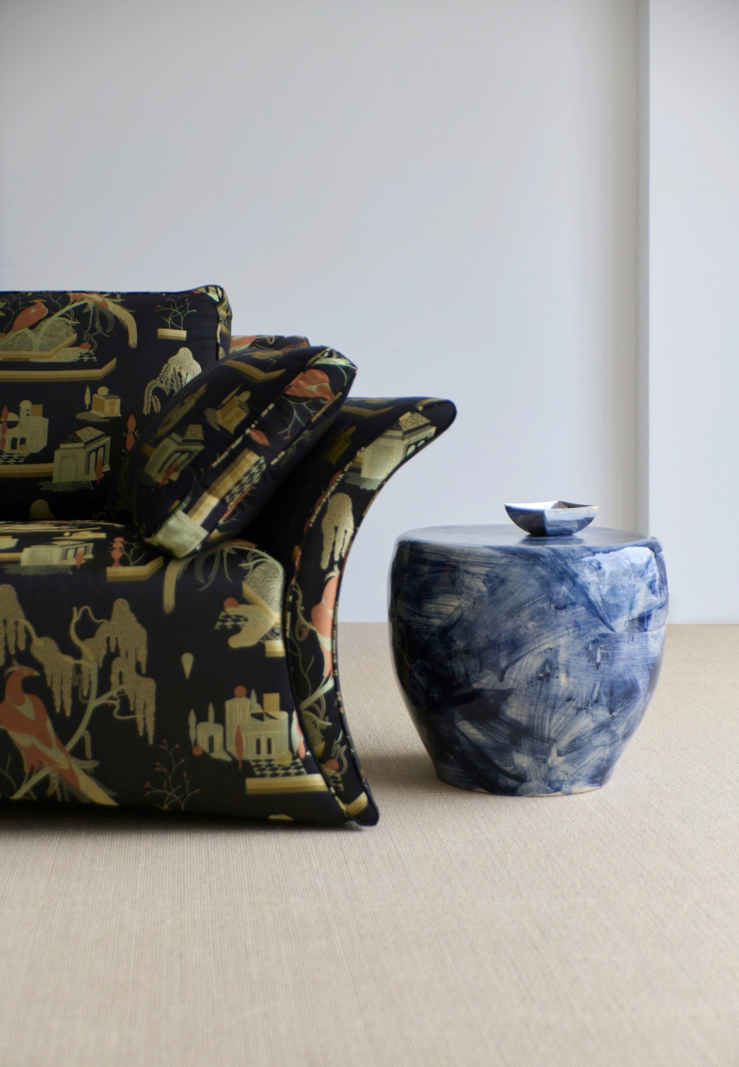 Medium Ceramic Side Table — back view beside patterned sofa