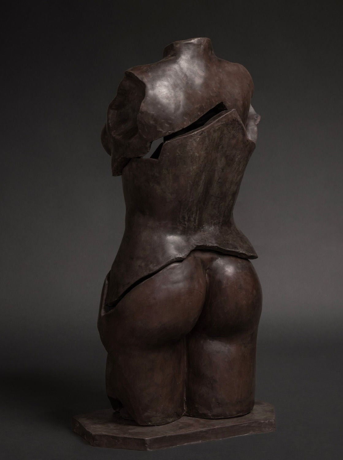 Female Figure Sculpture in Resin and Stone – Fragmentia Triad 03 by Marcela Cure — back view highlighting textured dark surfa