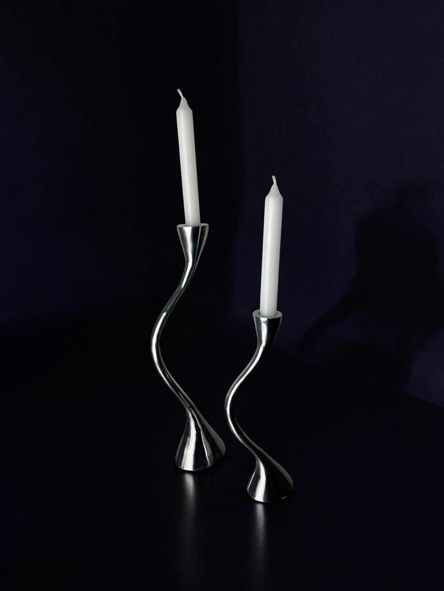 Pair of Zigzag Candleholders, Solid Aluminium, Spain, 1980s — side angle on dark surface