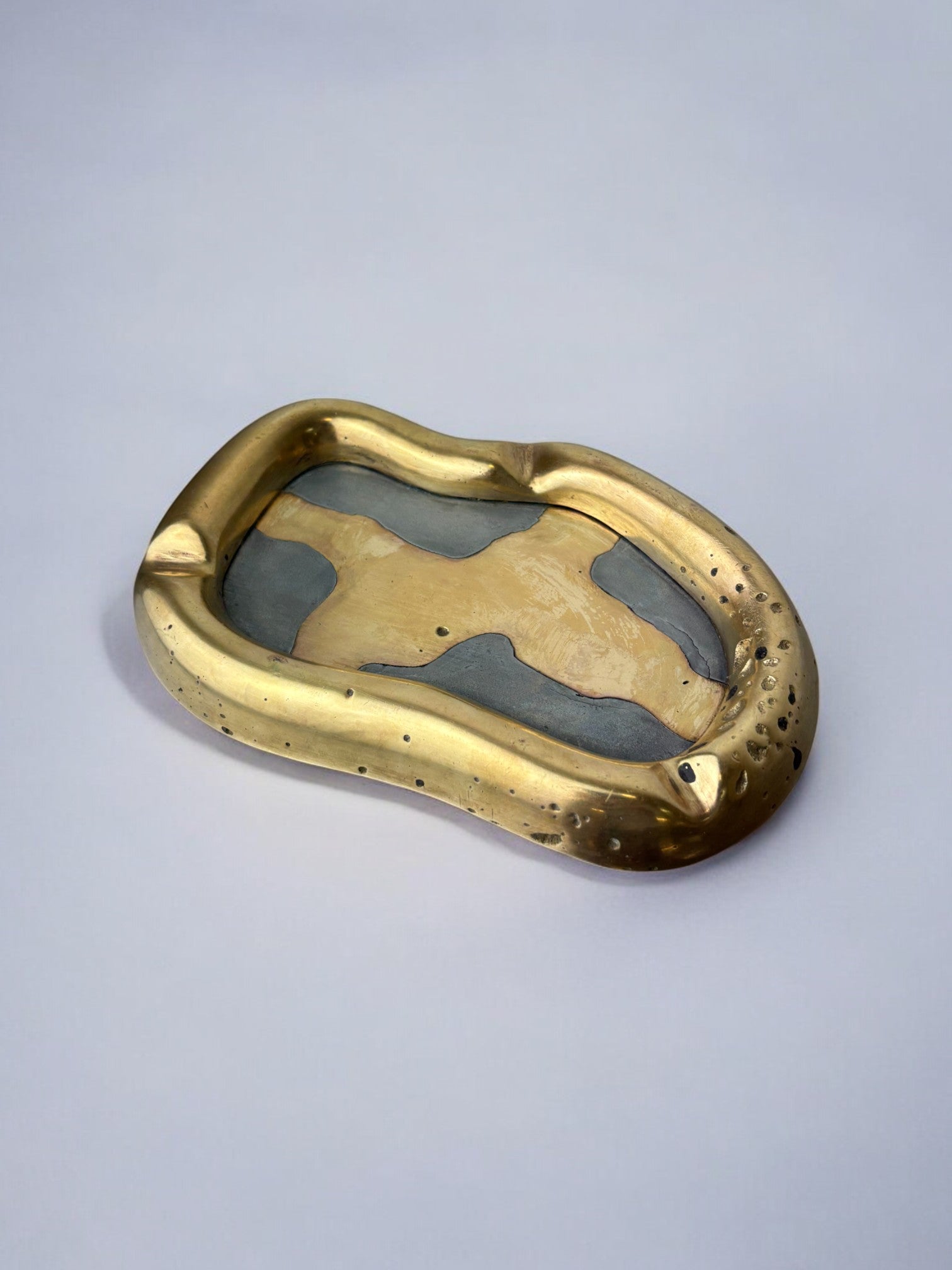 Brutalist ashtray by David Marshall, Spain, 70's — side angle showing brass and gray surface