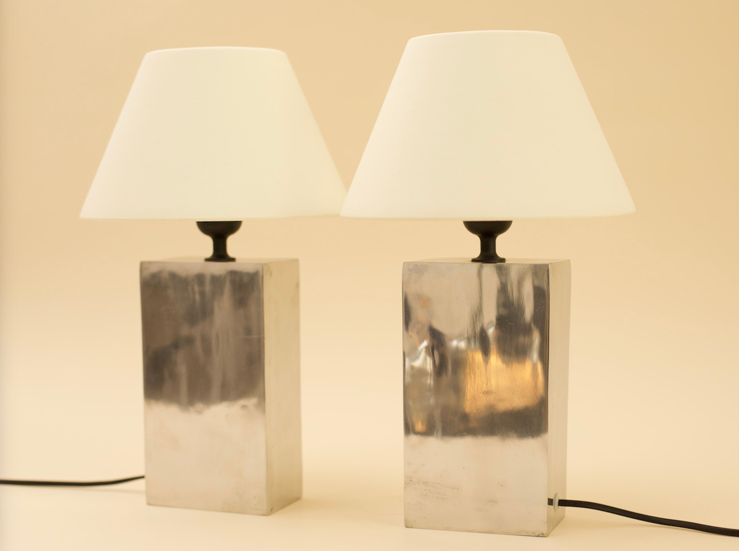 LAZSLO Pair of Table Lamps — close-up of polished metal base and white shade