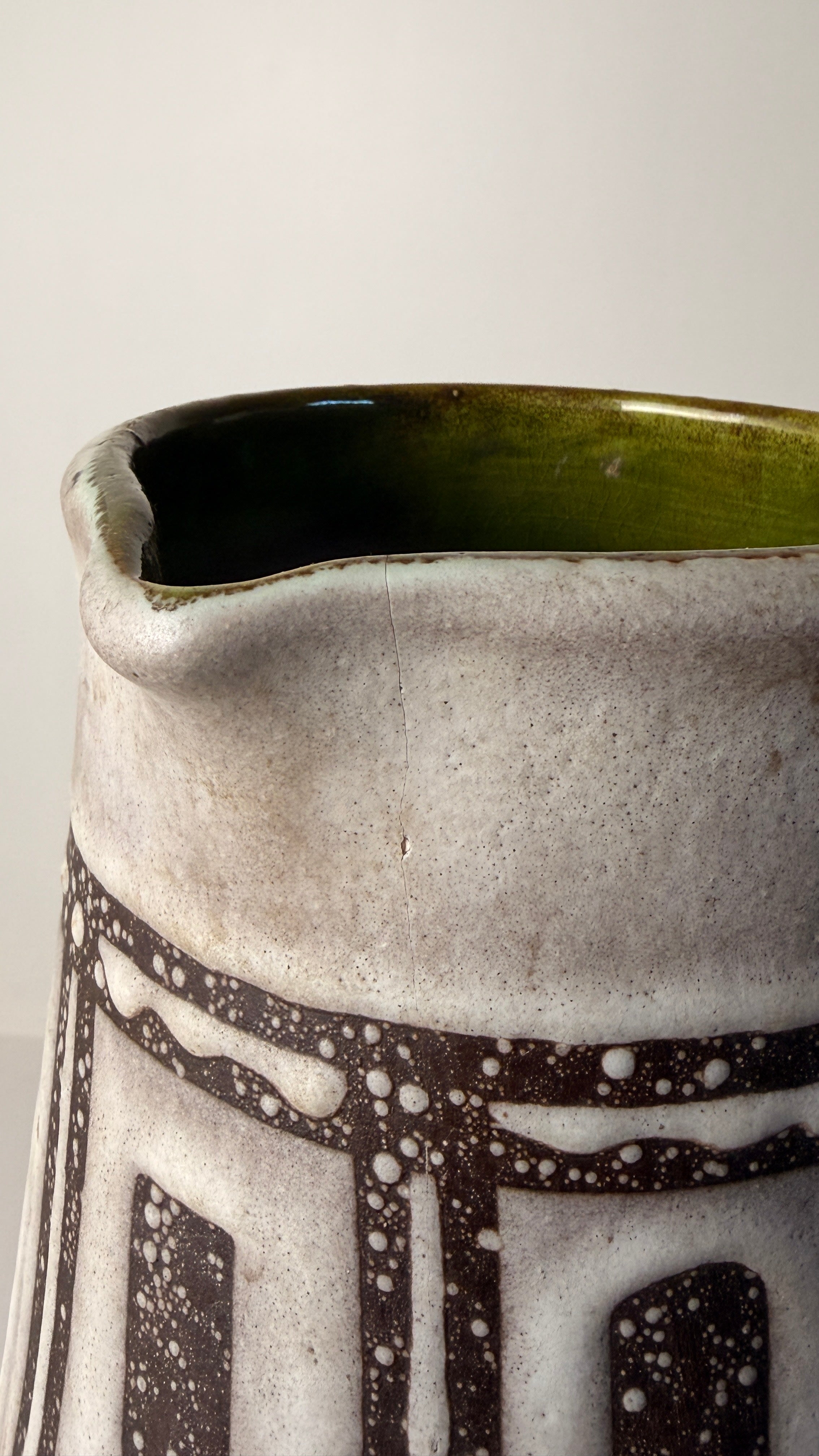 Ceramic pitcher, Germany, circa 1960. — close-up of textured surface with green interior