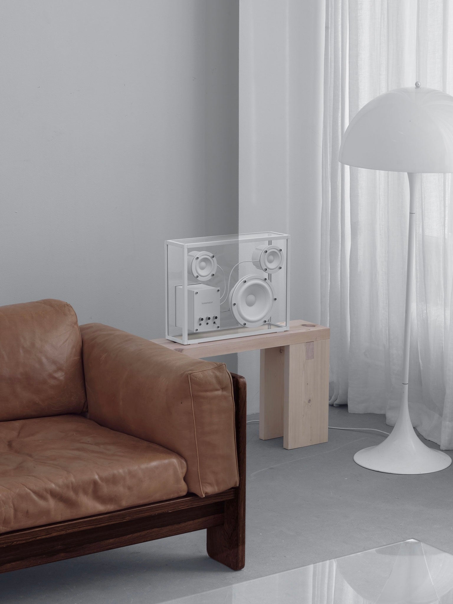 Transparent Speaker White - Bluetooth — top view on wooden table in modern living room
