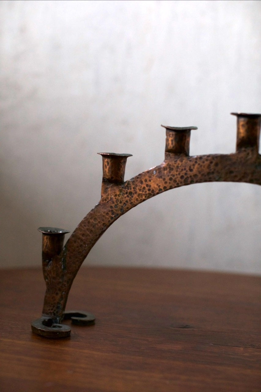 Bronze Candleholder — angled view highlighting textured surface on wooden table