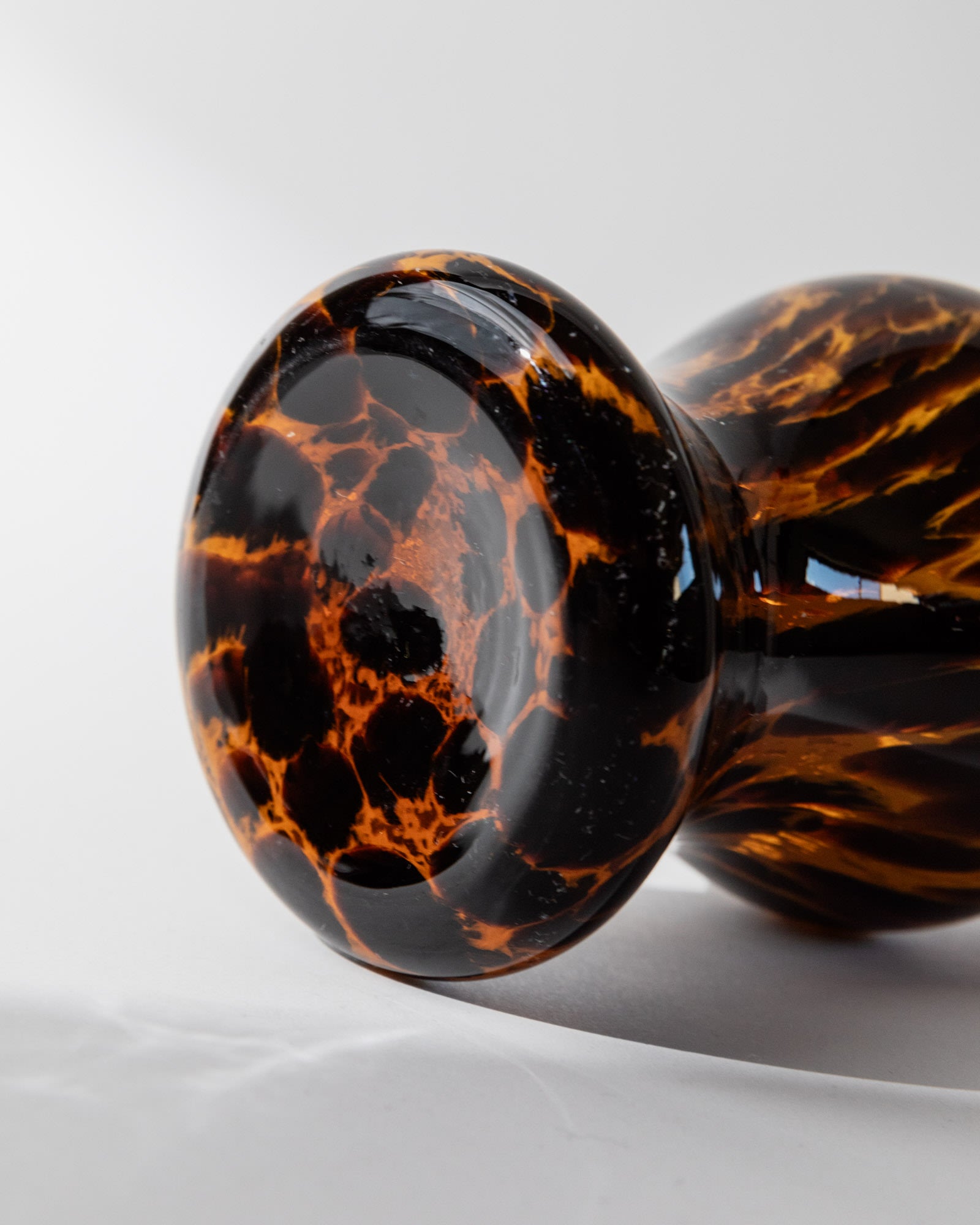 Close-up detail of tortoiseshell Murano glass vase with amber veining