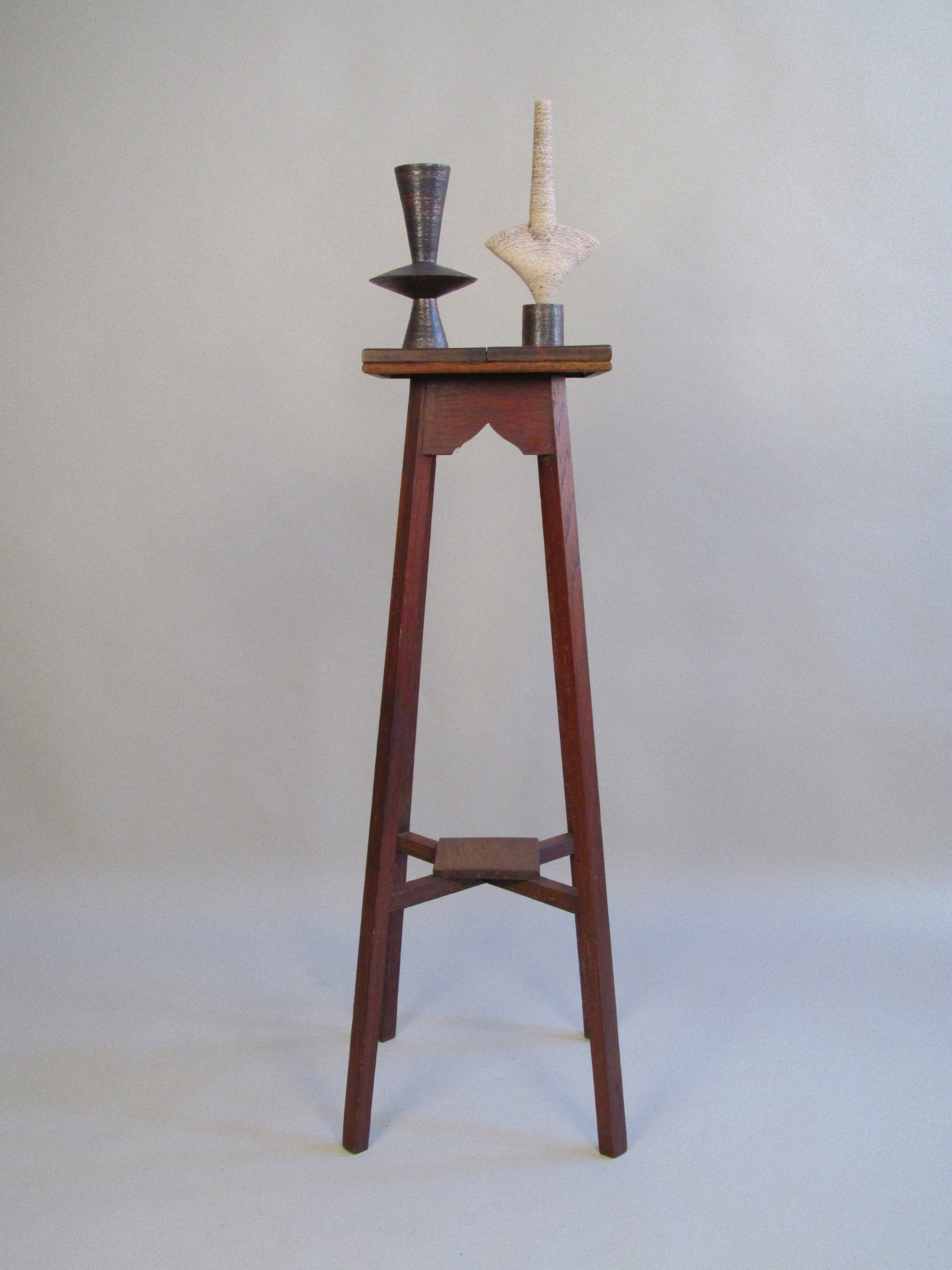Pair of Dameon Lynn Ceramic Forms — top view of ceramic sculptures on wooden stand
