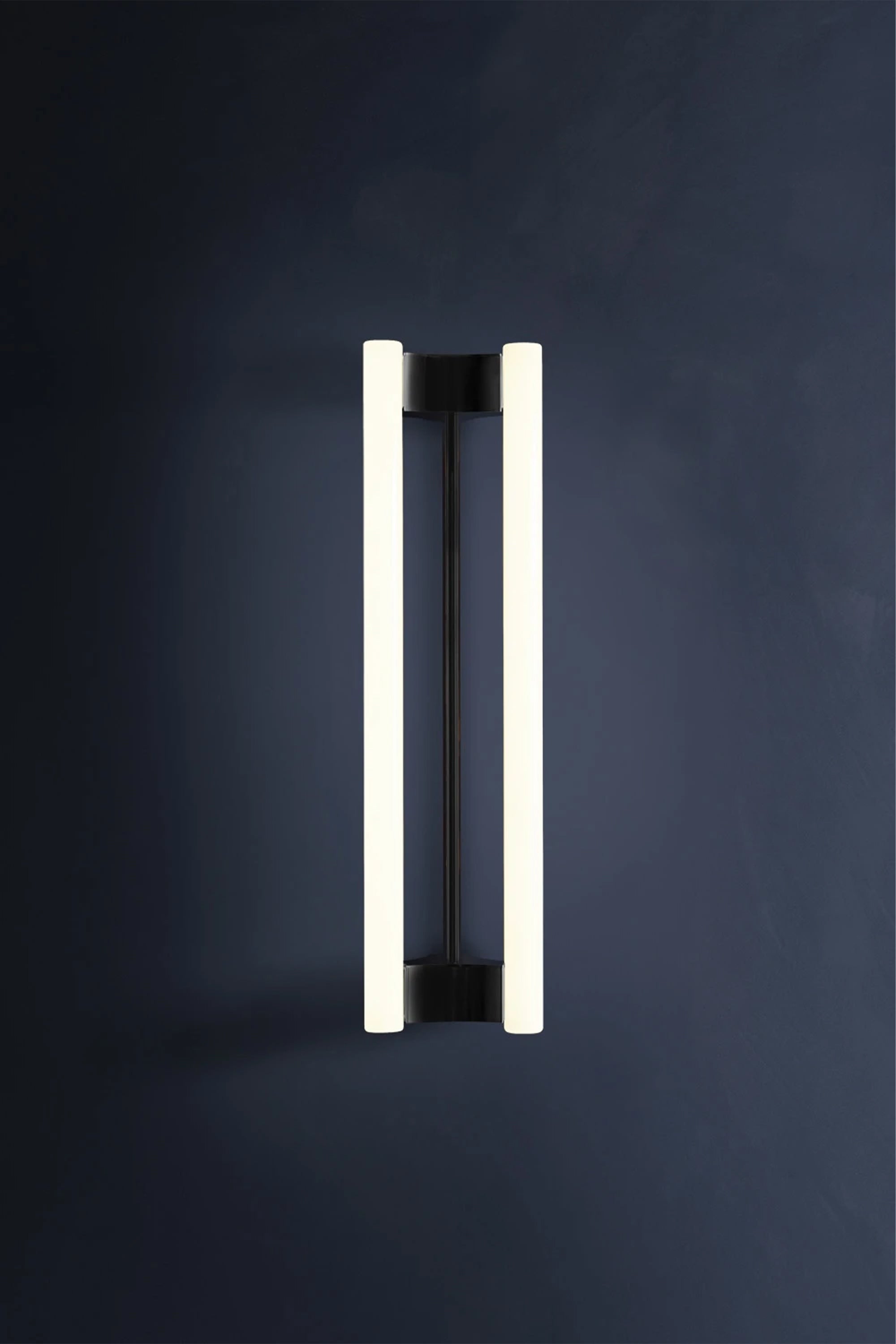 LIA WALL SCONCE 50 — modern black and white wall light on dark wall