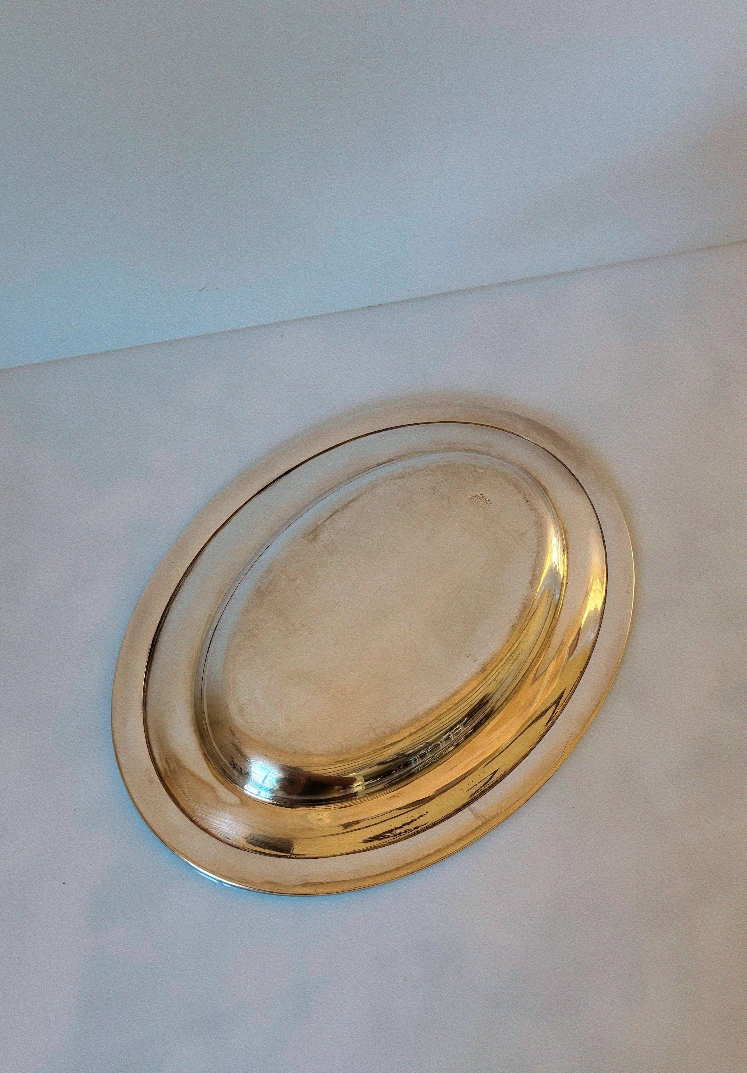 Silver plated oval serving platter detail view on white surface