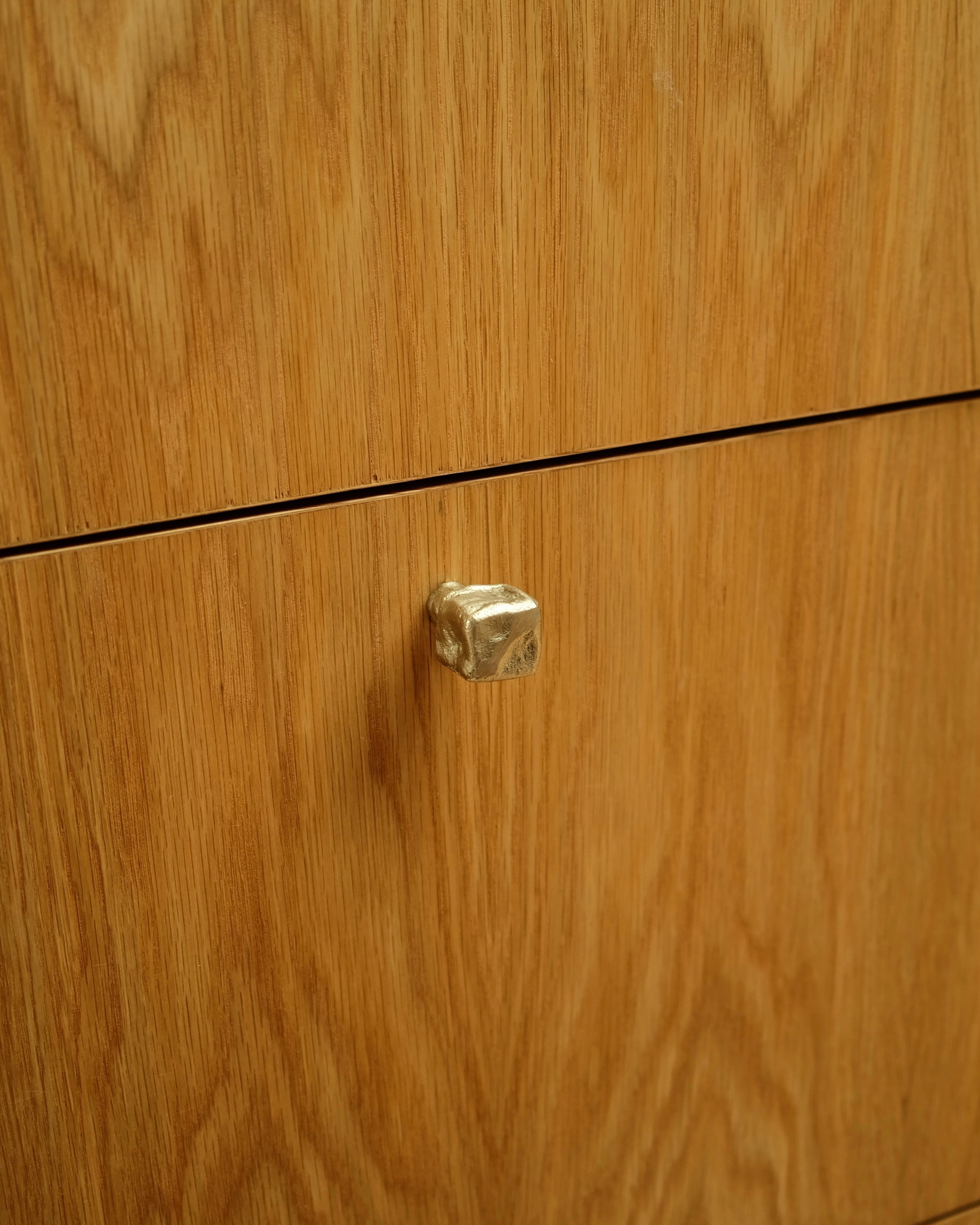 ISLE Cabinet Knob/Wall Hook Small — side angle of brass knob on wooden cabinet