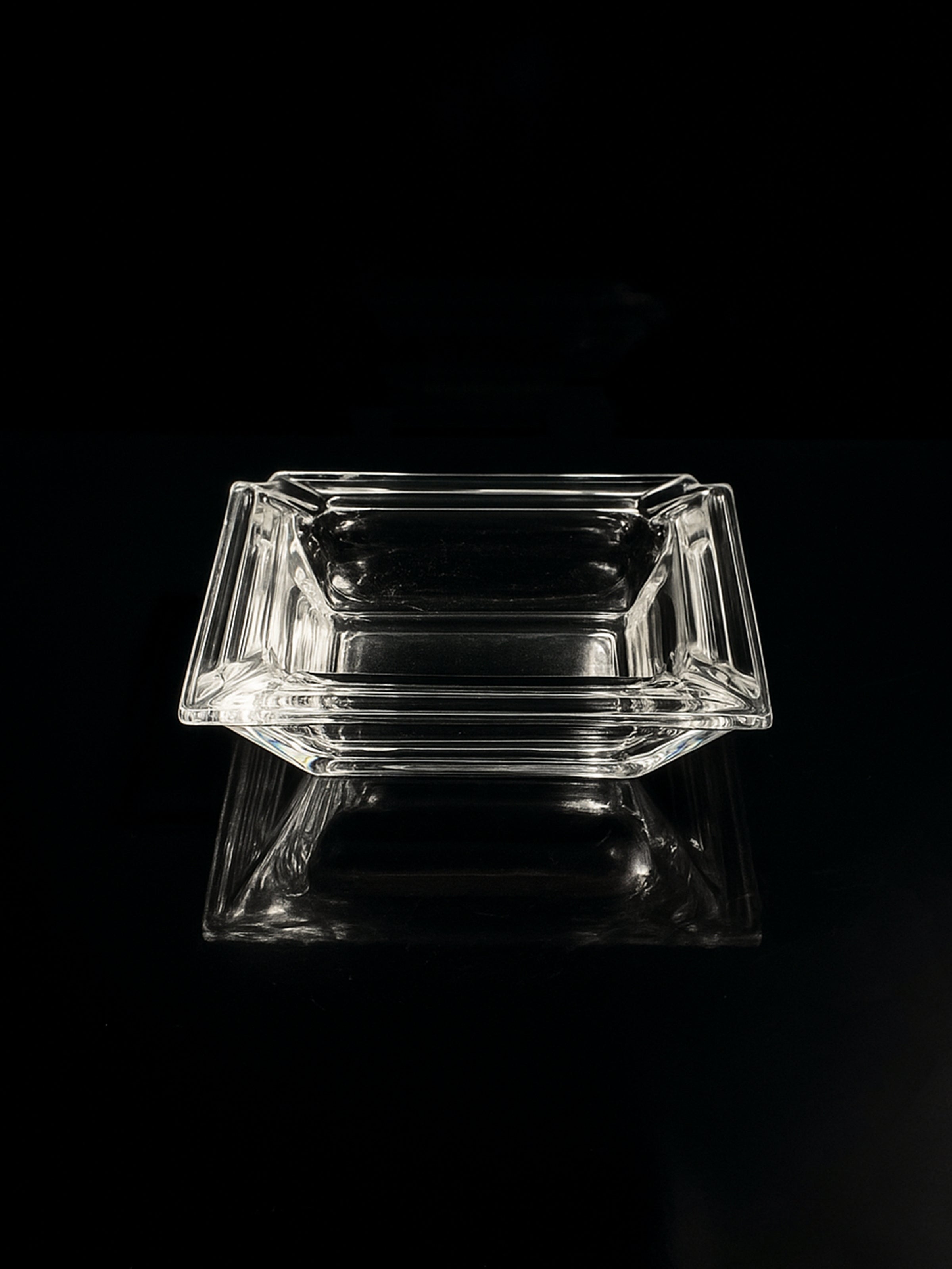 Italian Art Deco crystal glass ashtray / vide poche — top view on black surface
