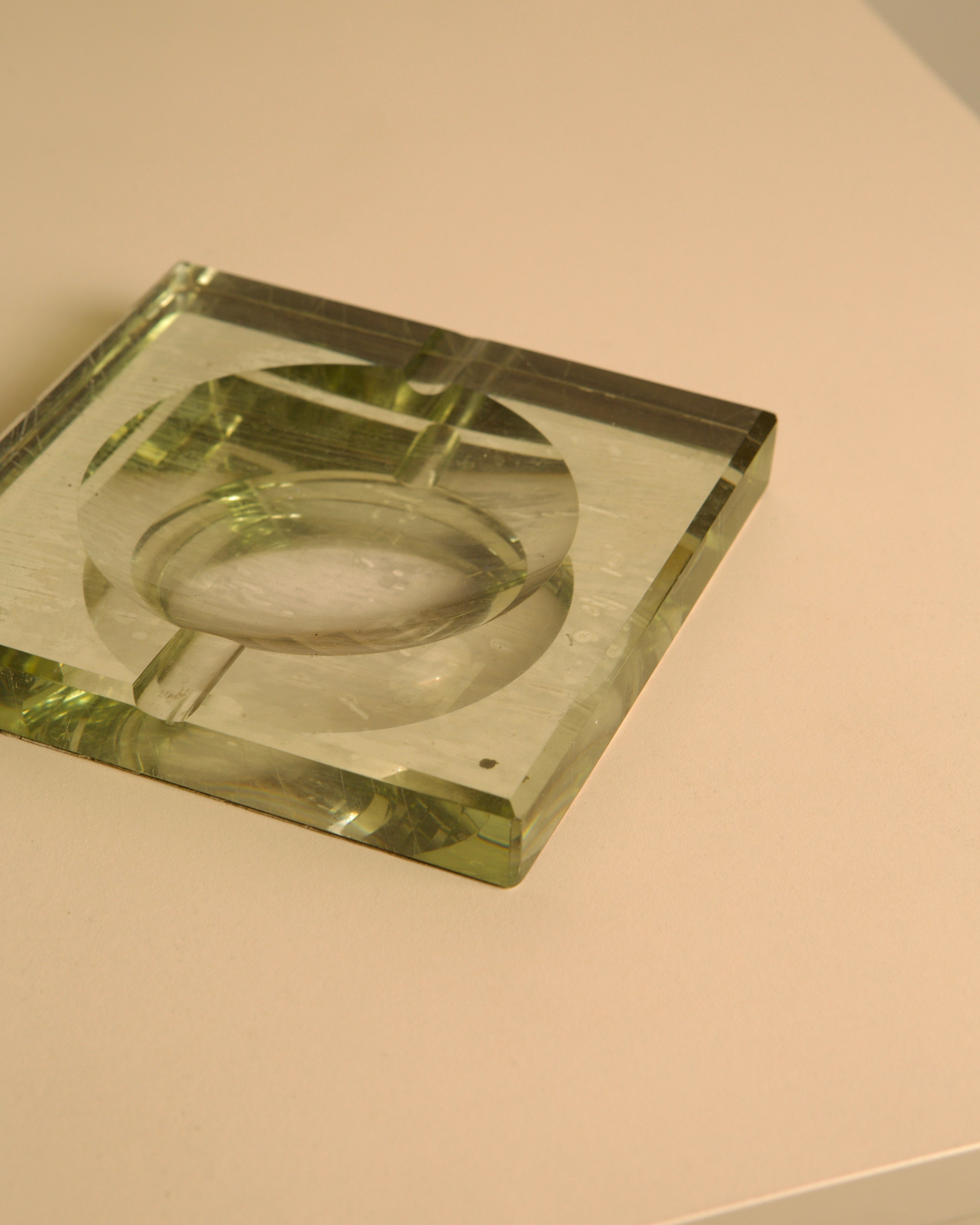 Green glass Saint Gobain ashtray showing circular detail view