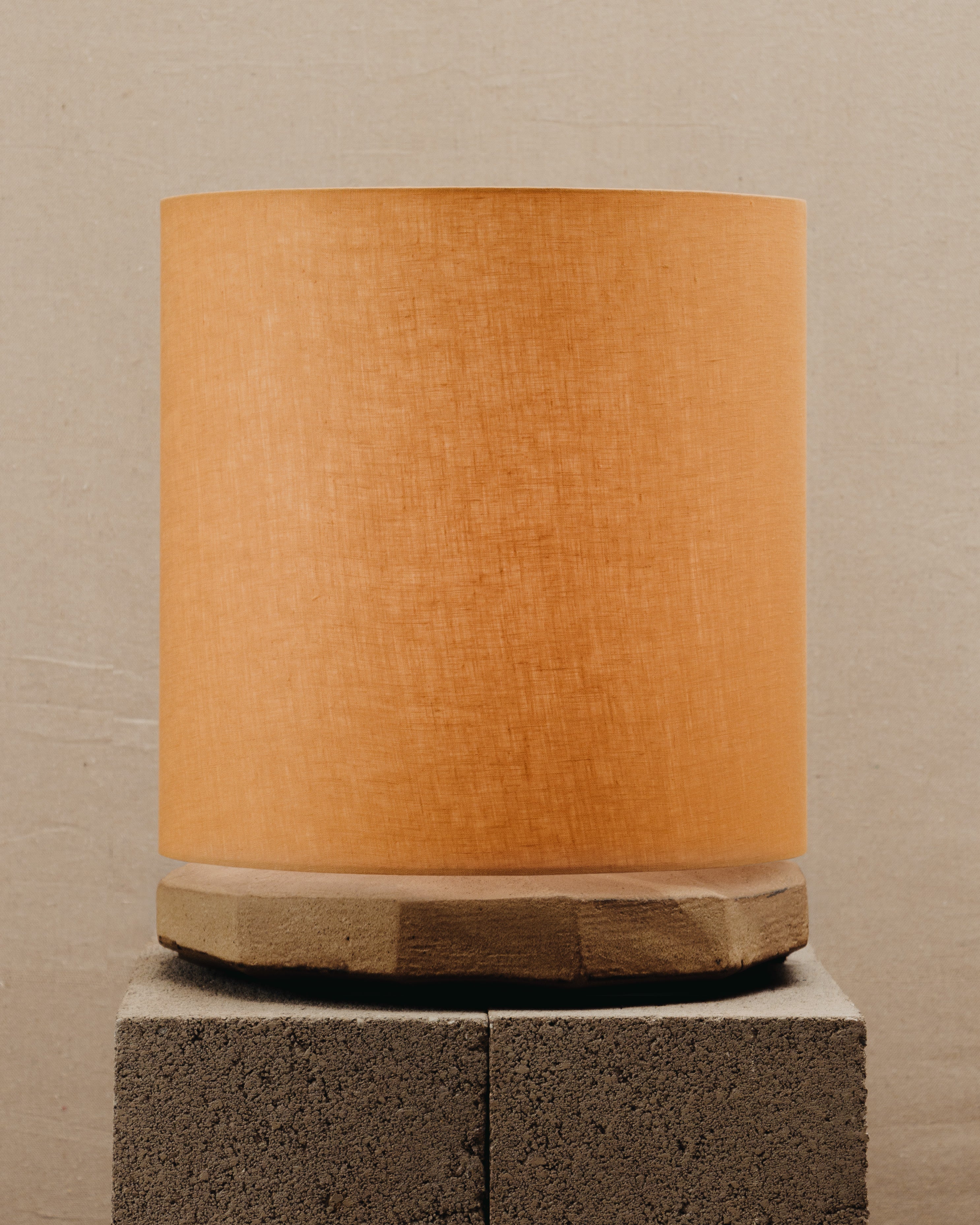 Radian Lamp — top view of orange fabric shade on stone base