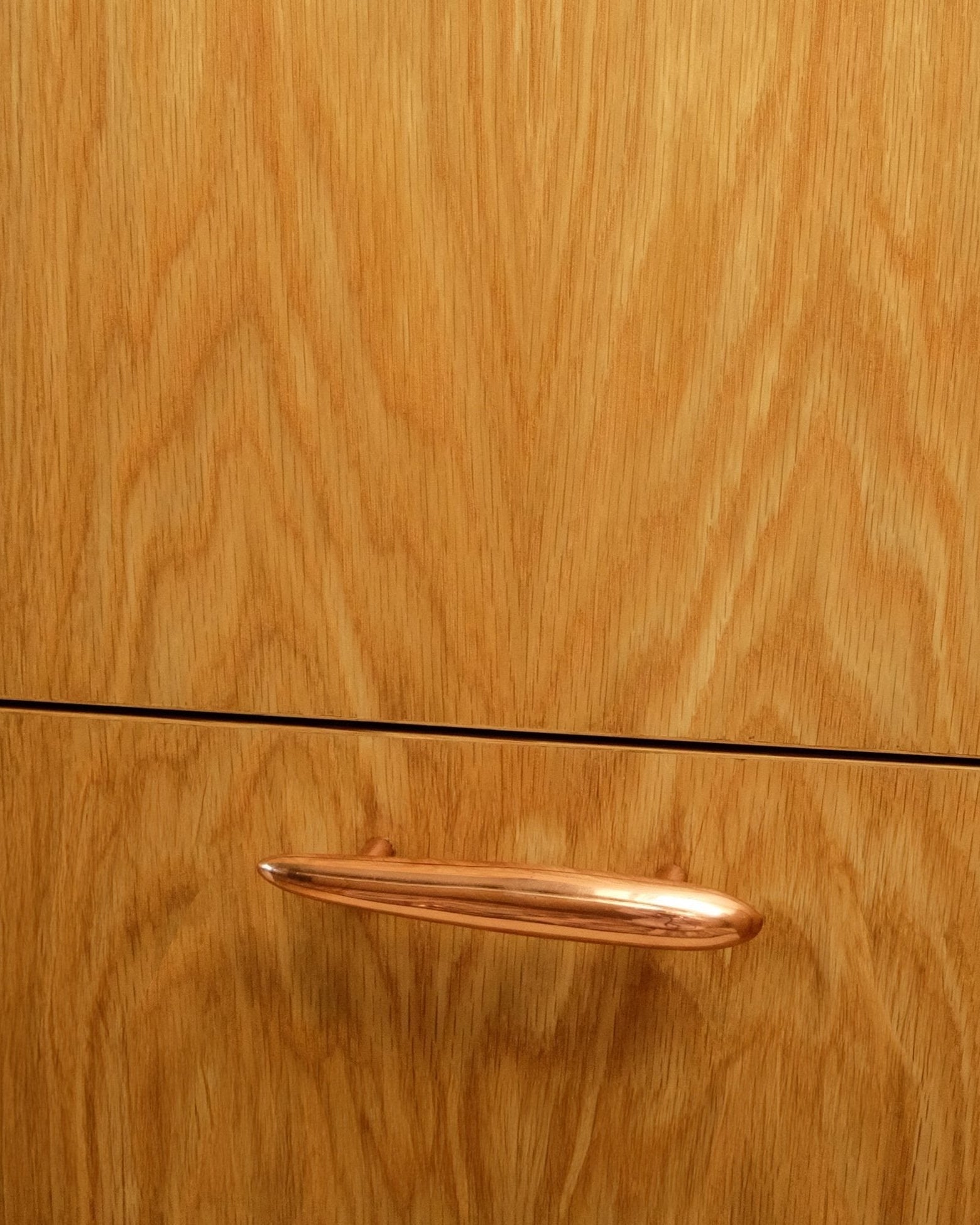 MOMI Cabinet Pull — close-up of copper handle on wooden cabinet