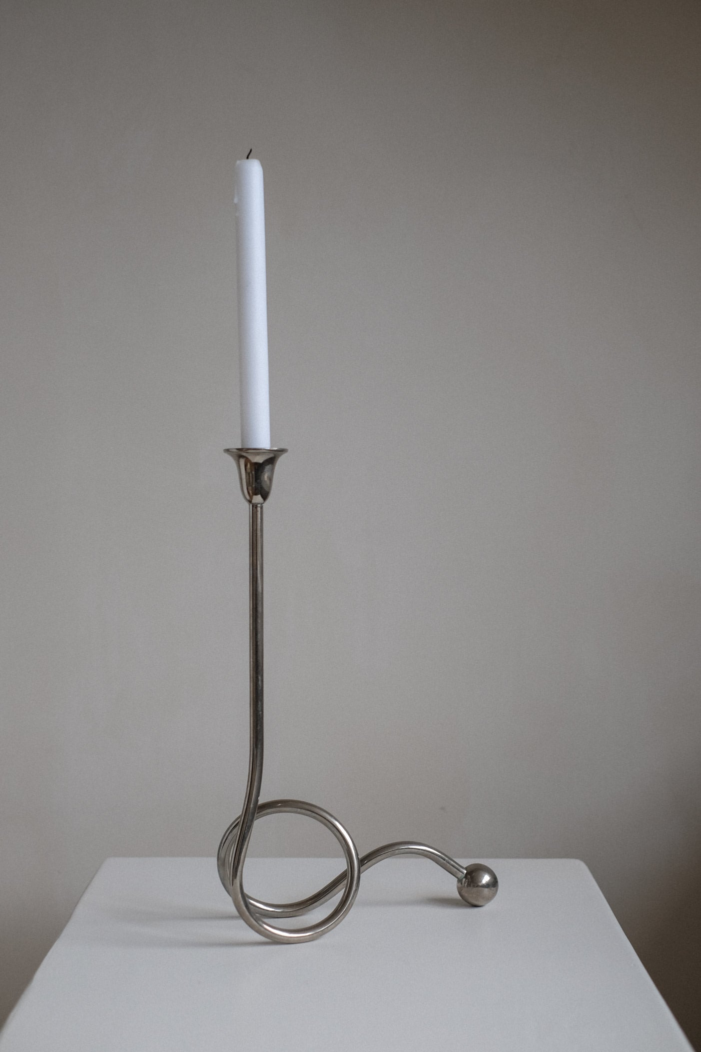 Chrome Candle Holder by Guido Niest — side view highlighting chrome finish and candle