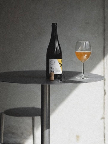 Table - Isla x Paul Delrez - Stainless Steel — back view with drink and glass