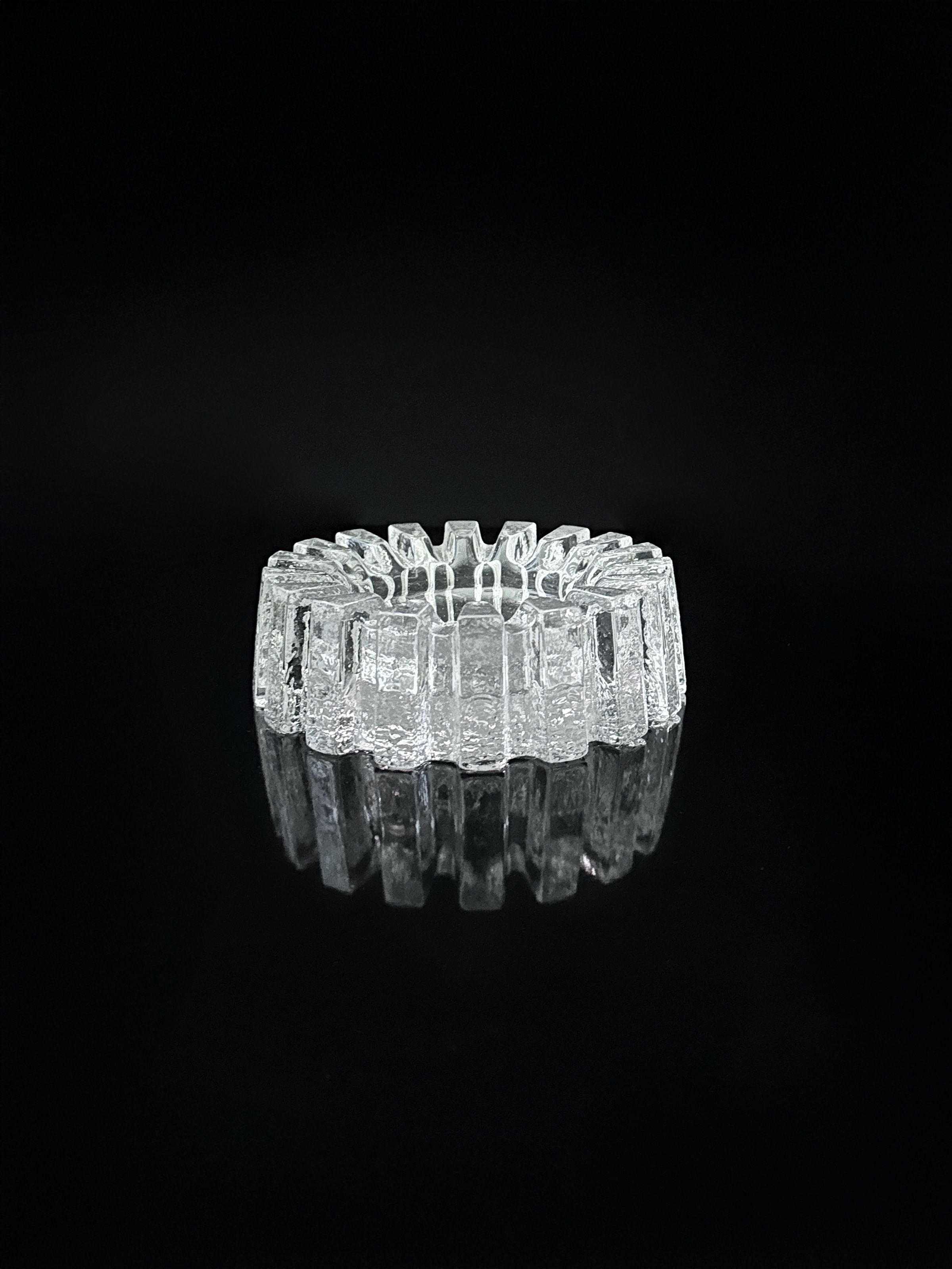 1970s Crystal Glass Brutalist Ashtray — top view on black surface