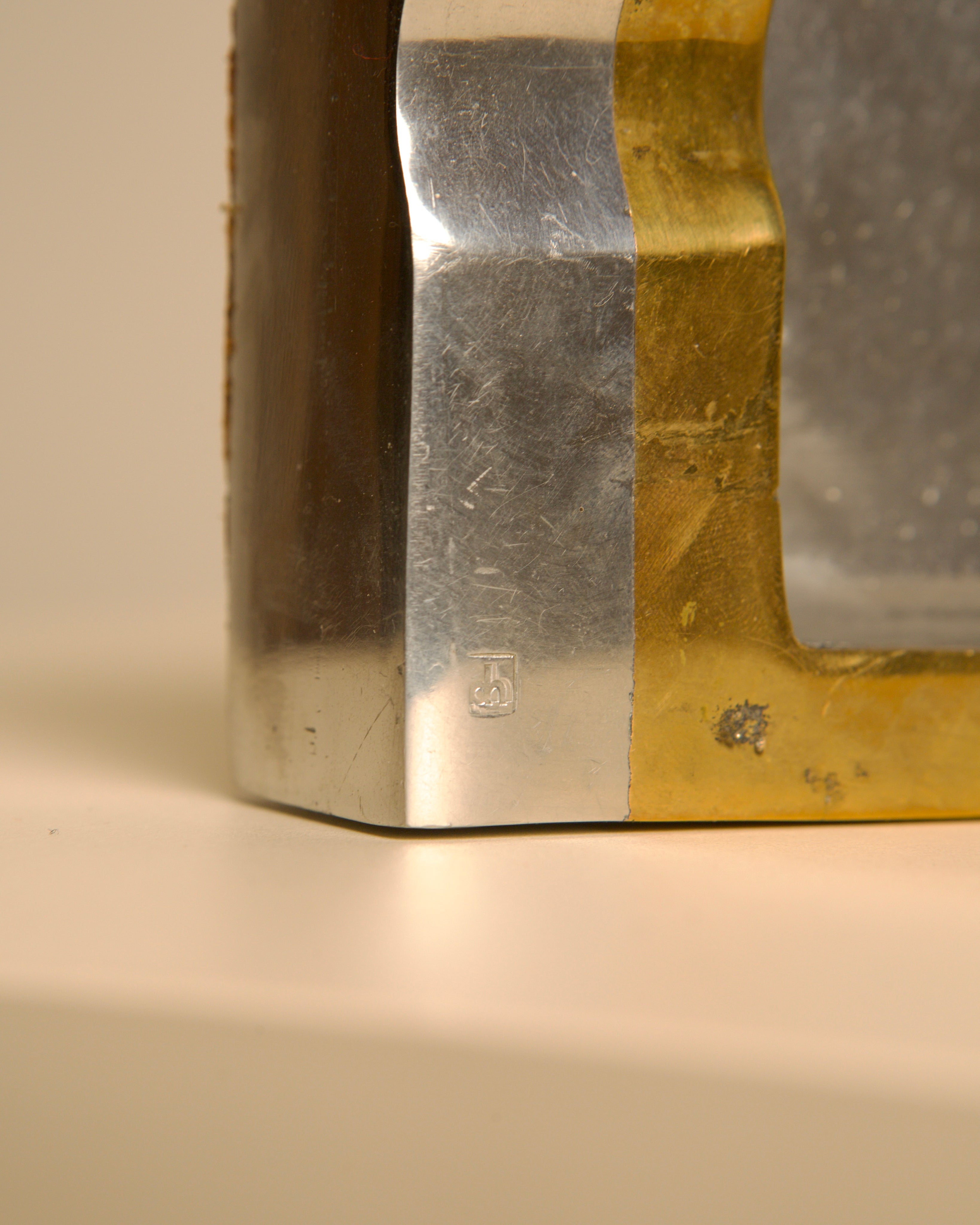 Close-up detail of brass and silver brutalist ashtray maker's mark