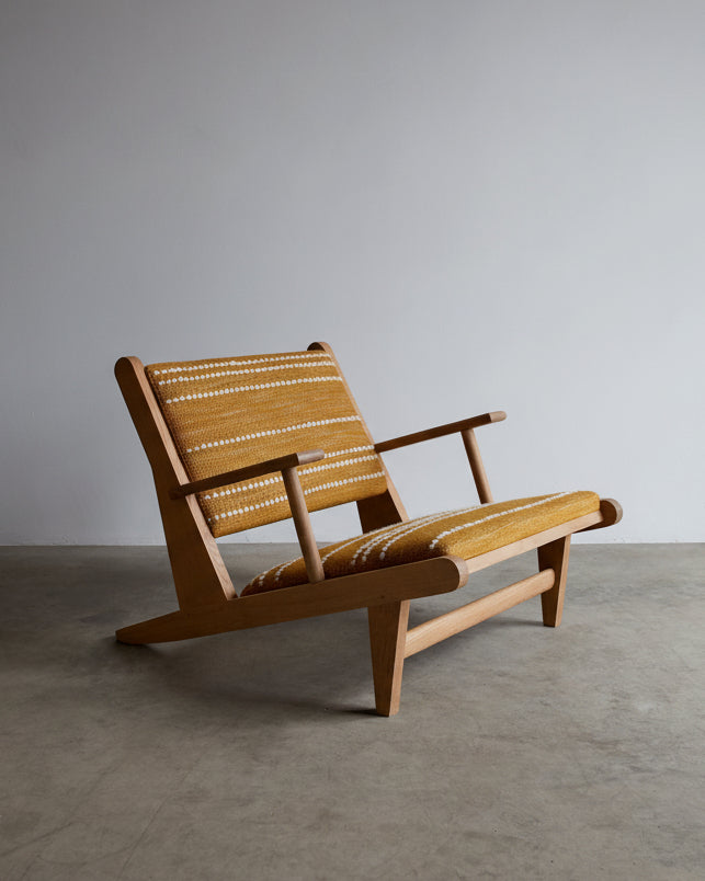 Hunting Chair — angled view highlighting woven yellow seat and wooden frame