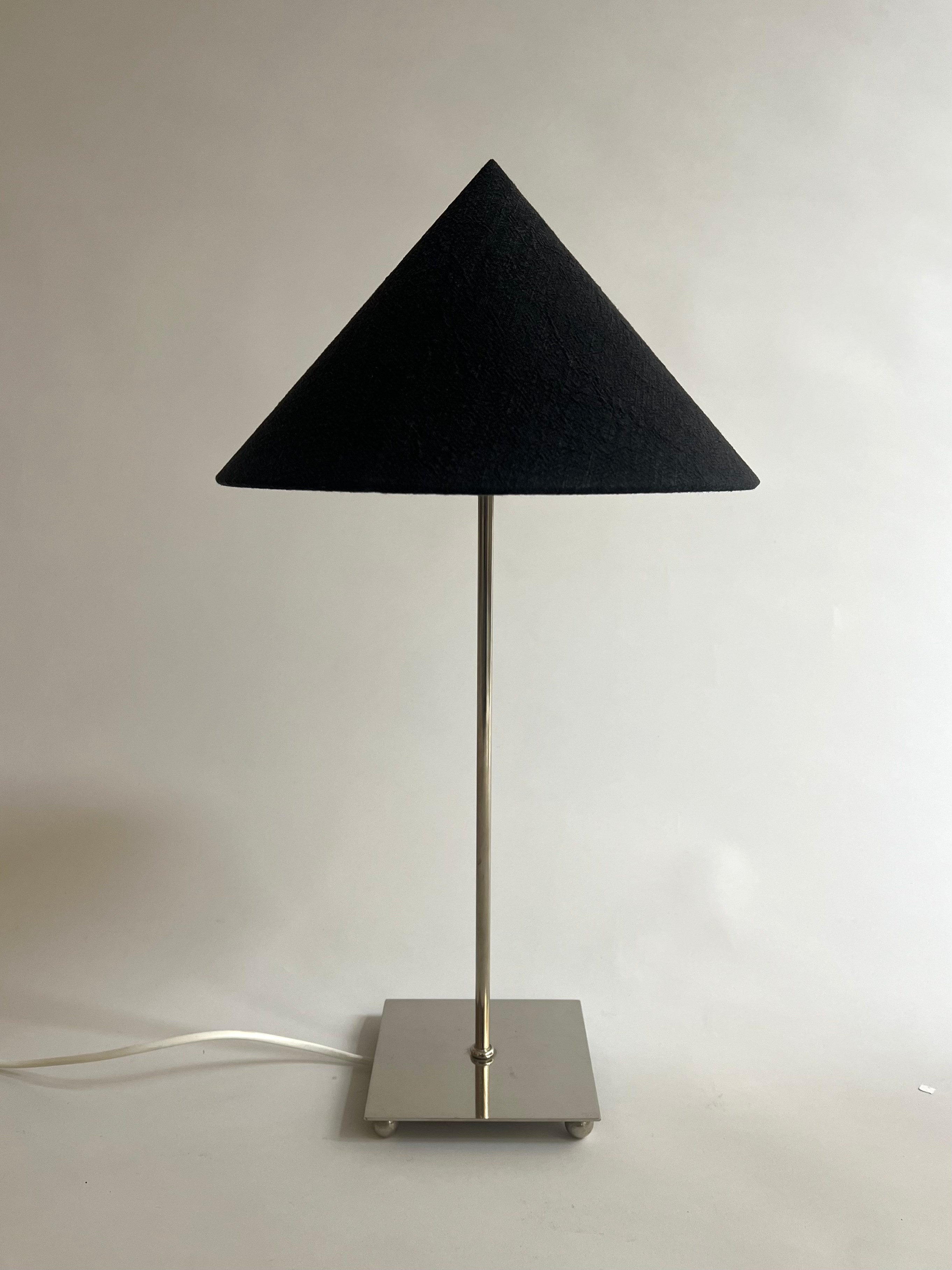 Levento' Table Lamp — side view showing black fabric shade and metal base