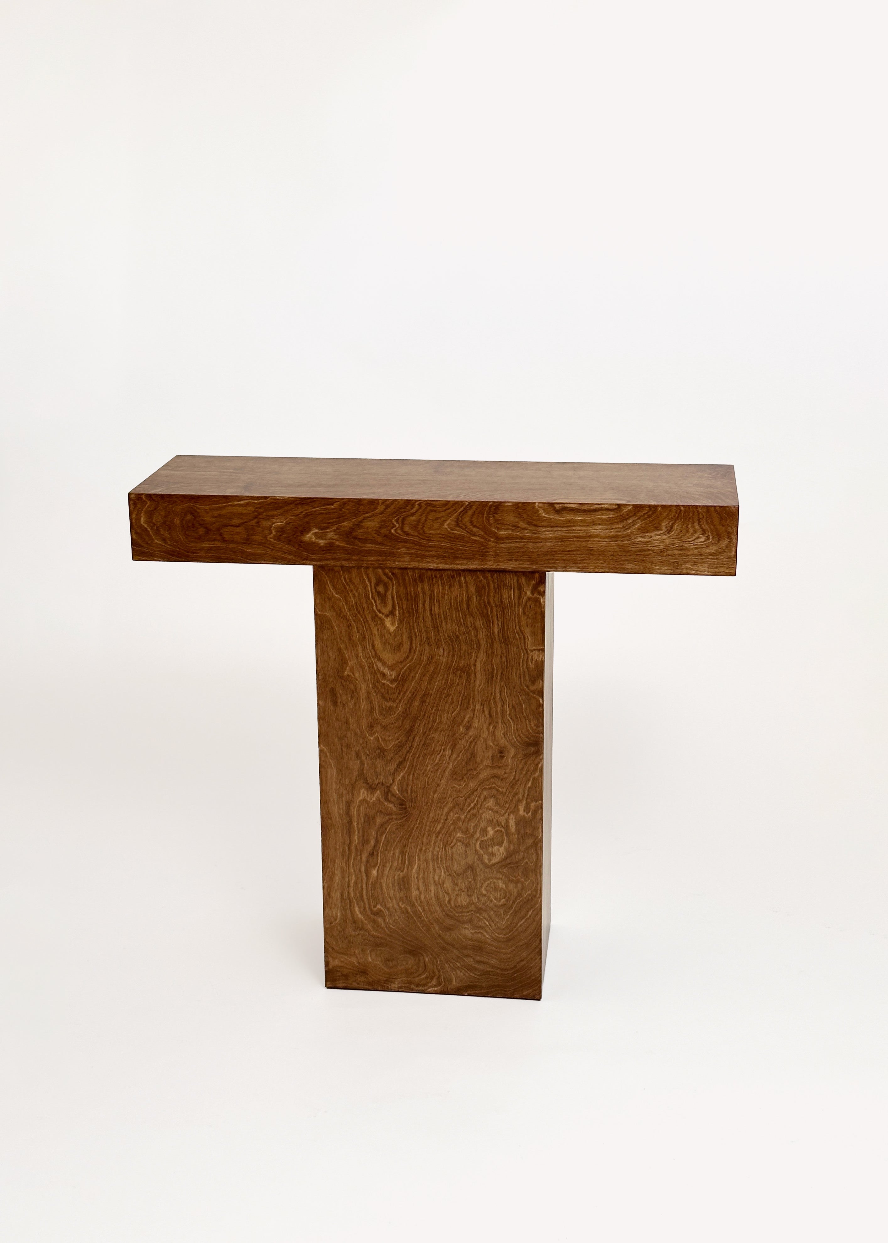 The Truss Console 02 by GOONS features a rectangular top and single vertical base with natural wood grain, crafted in the refined style of a Paris design studio, shown against a plain white background.