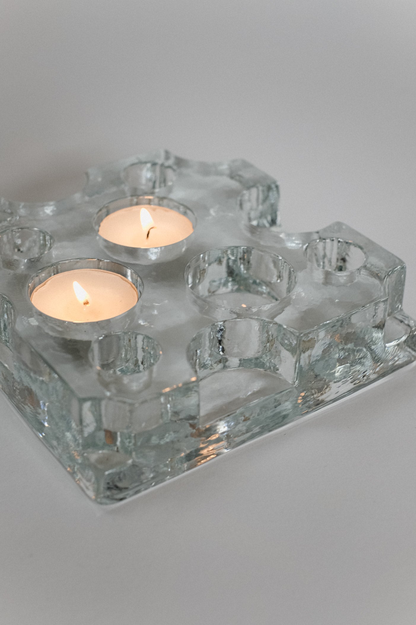 Glass Candle Holder — top view on neutral background with two candles