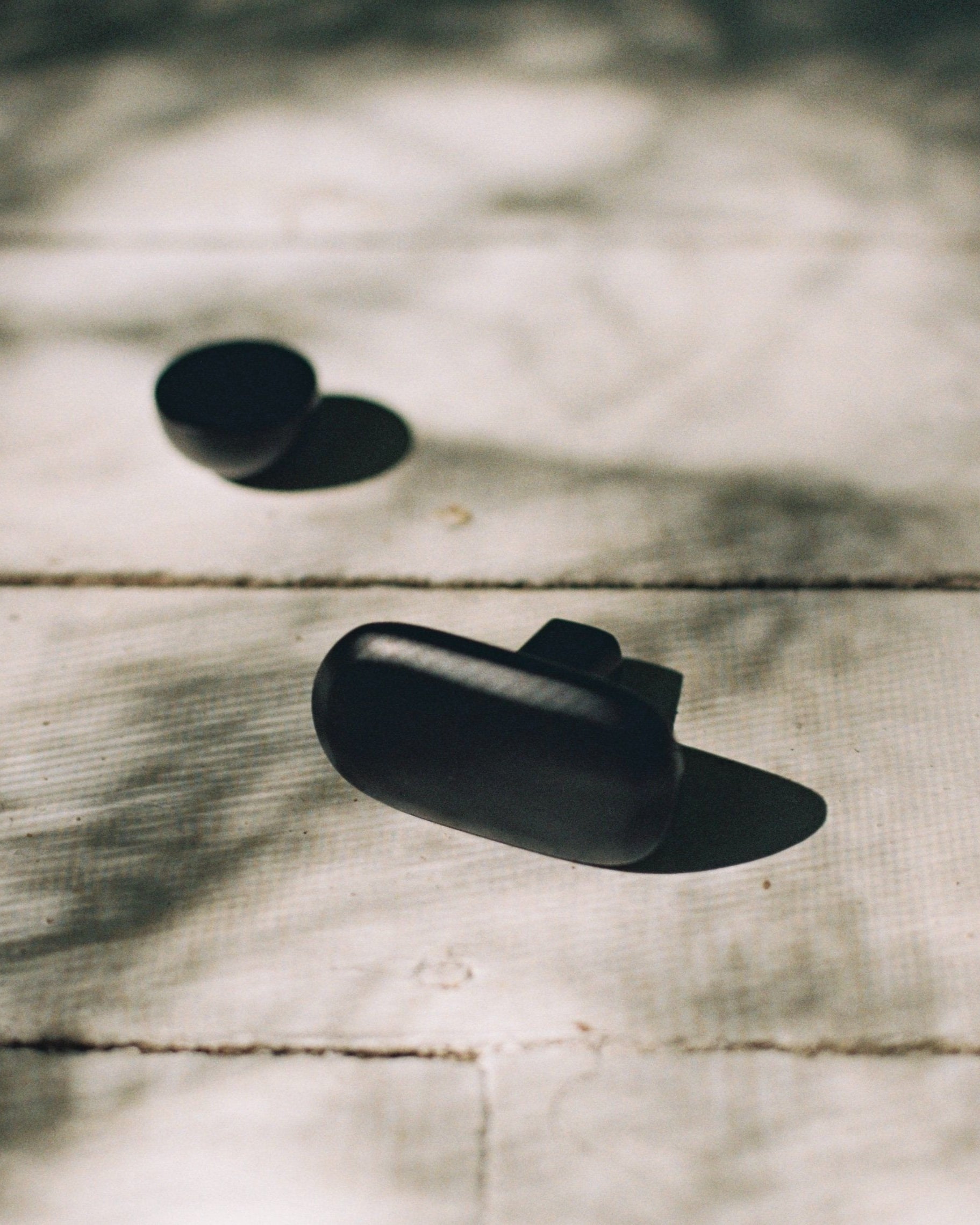 OVAL Cabinet Knob/Wall Hook — black knobs on wooden surface
