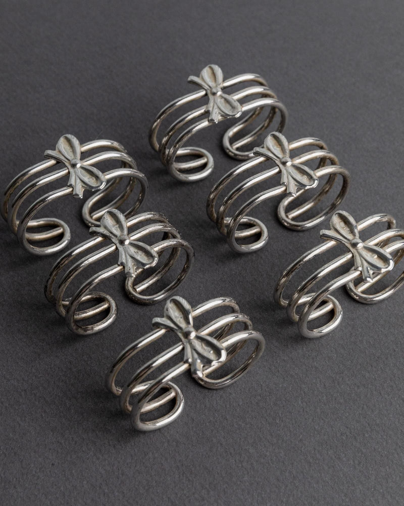 1970s Silver Plated Napkin Rings Set of 6 — close-up showing intricate bow design