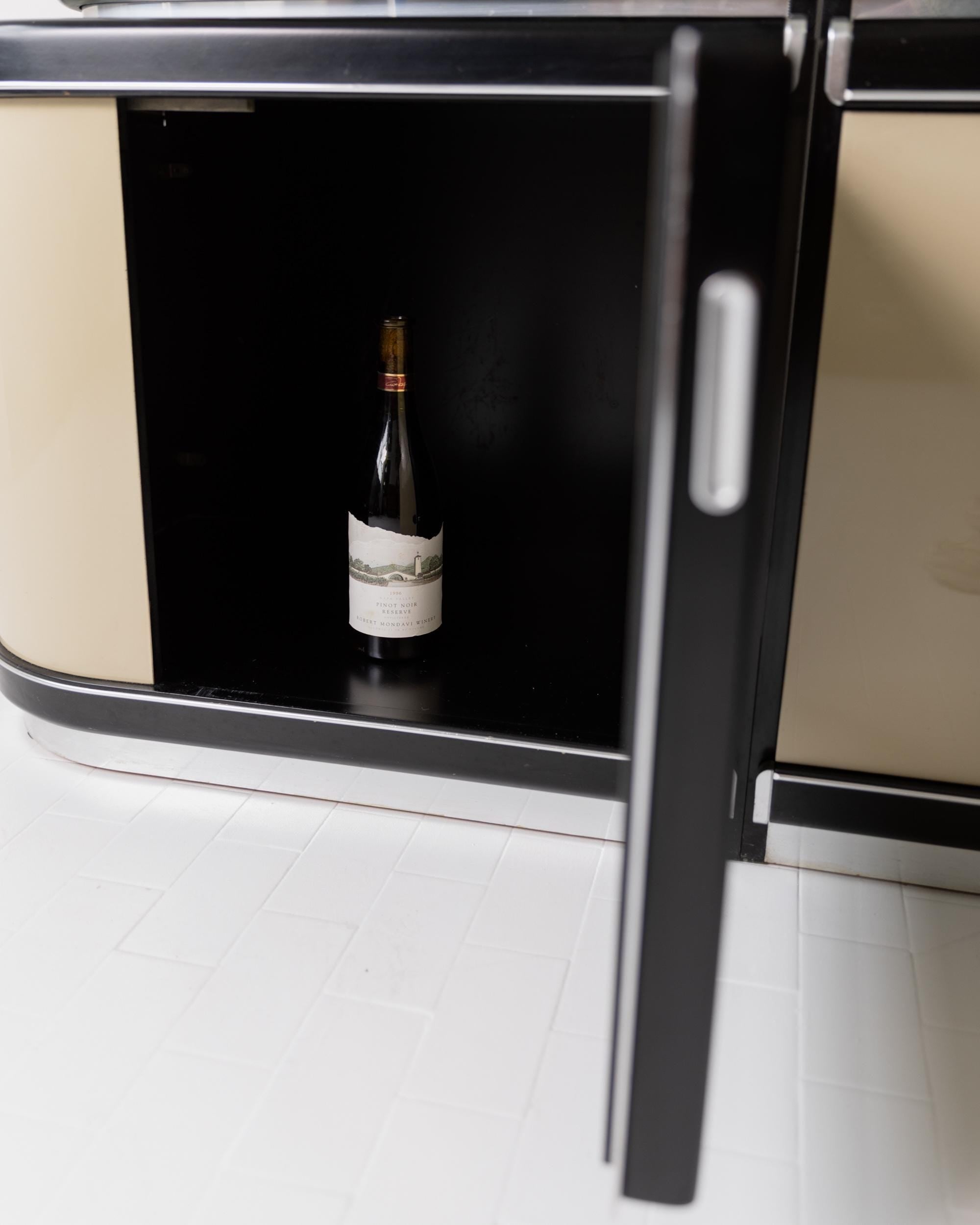1950s Art Deco Bar Cabinet in Lacquered Wood — interior view with wine bottle inside