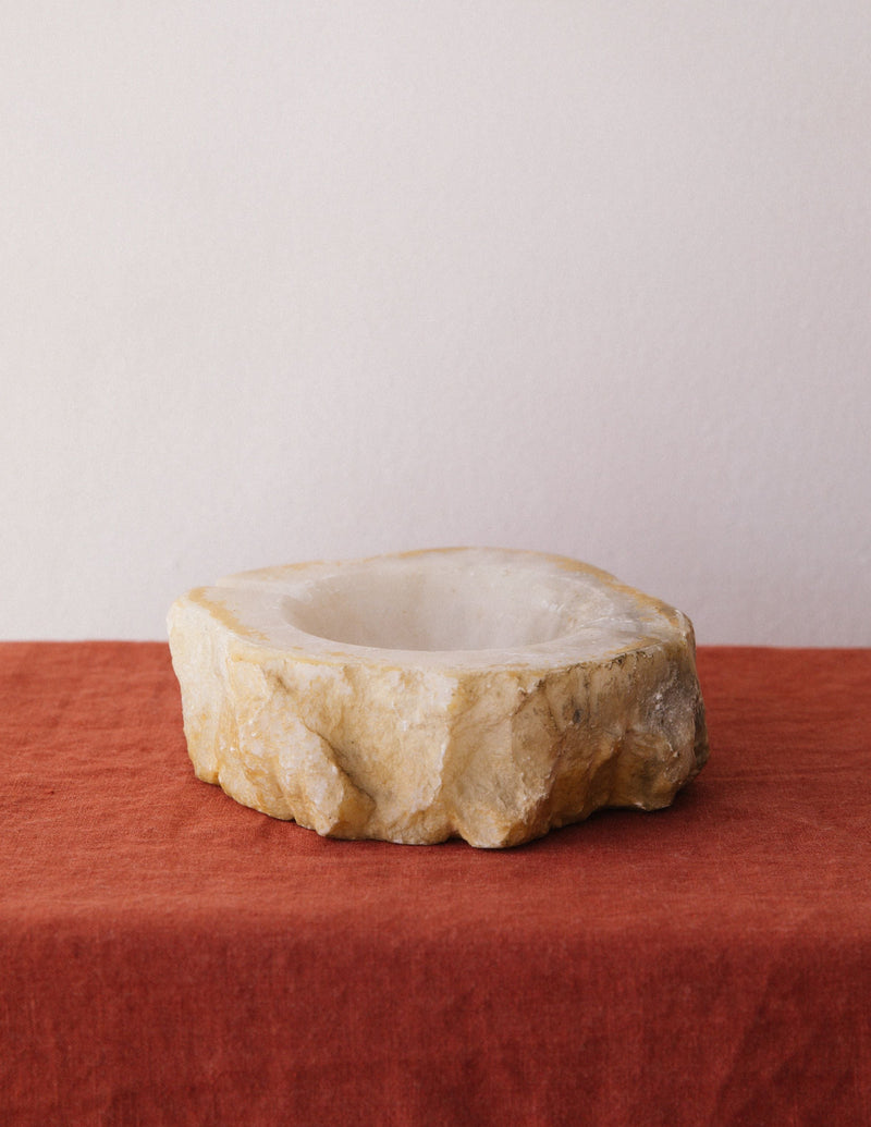 Round alabaster ashtray with natural stone texture and carved bowl