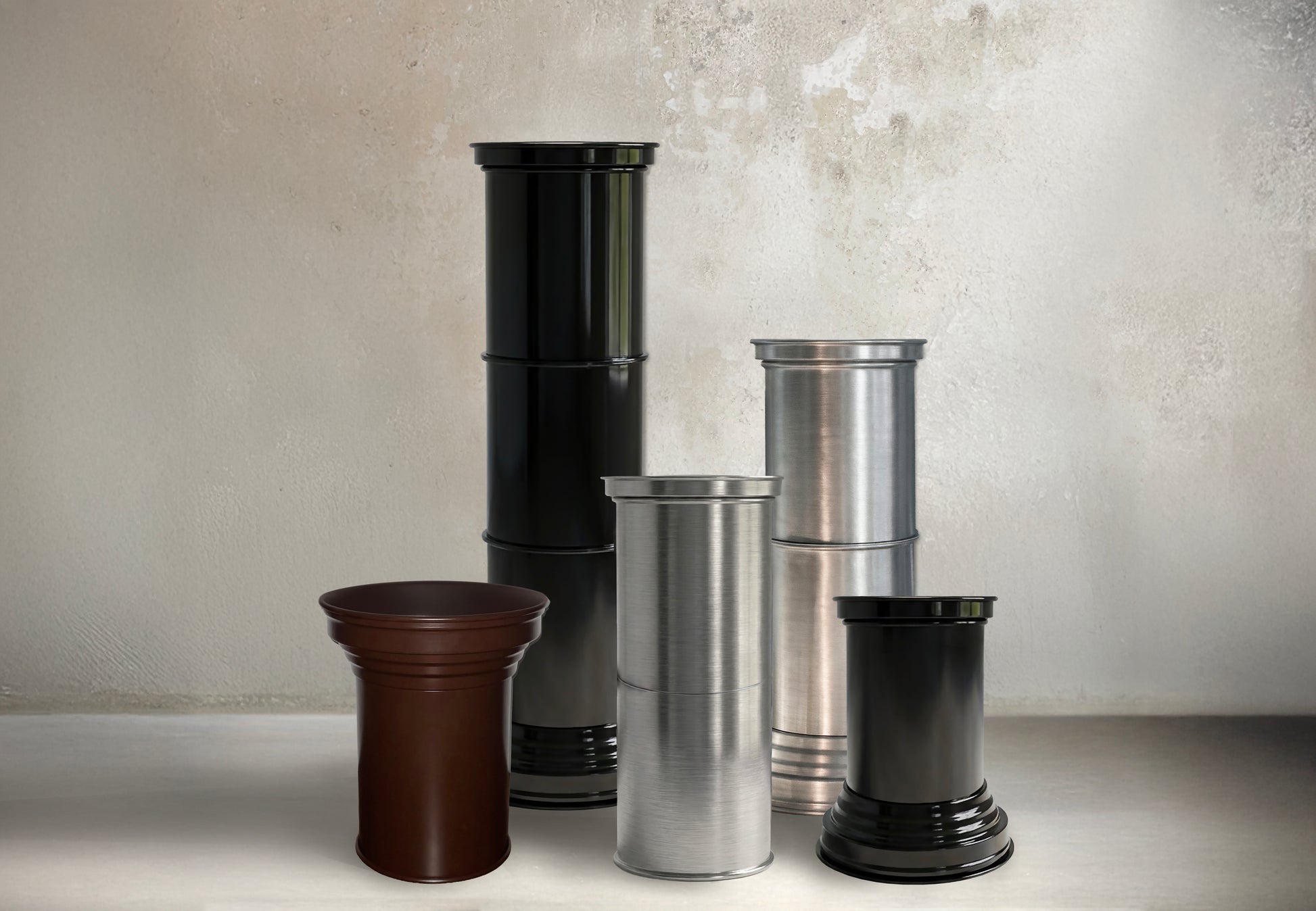 Contemporary End Tables in Mirror Metal — side angle of stacked cylindrical tables