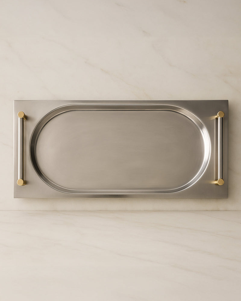Overhead view of extra long silver serving tray with brass handles