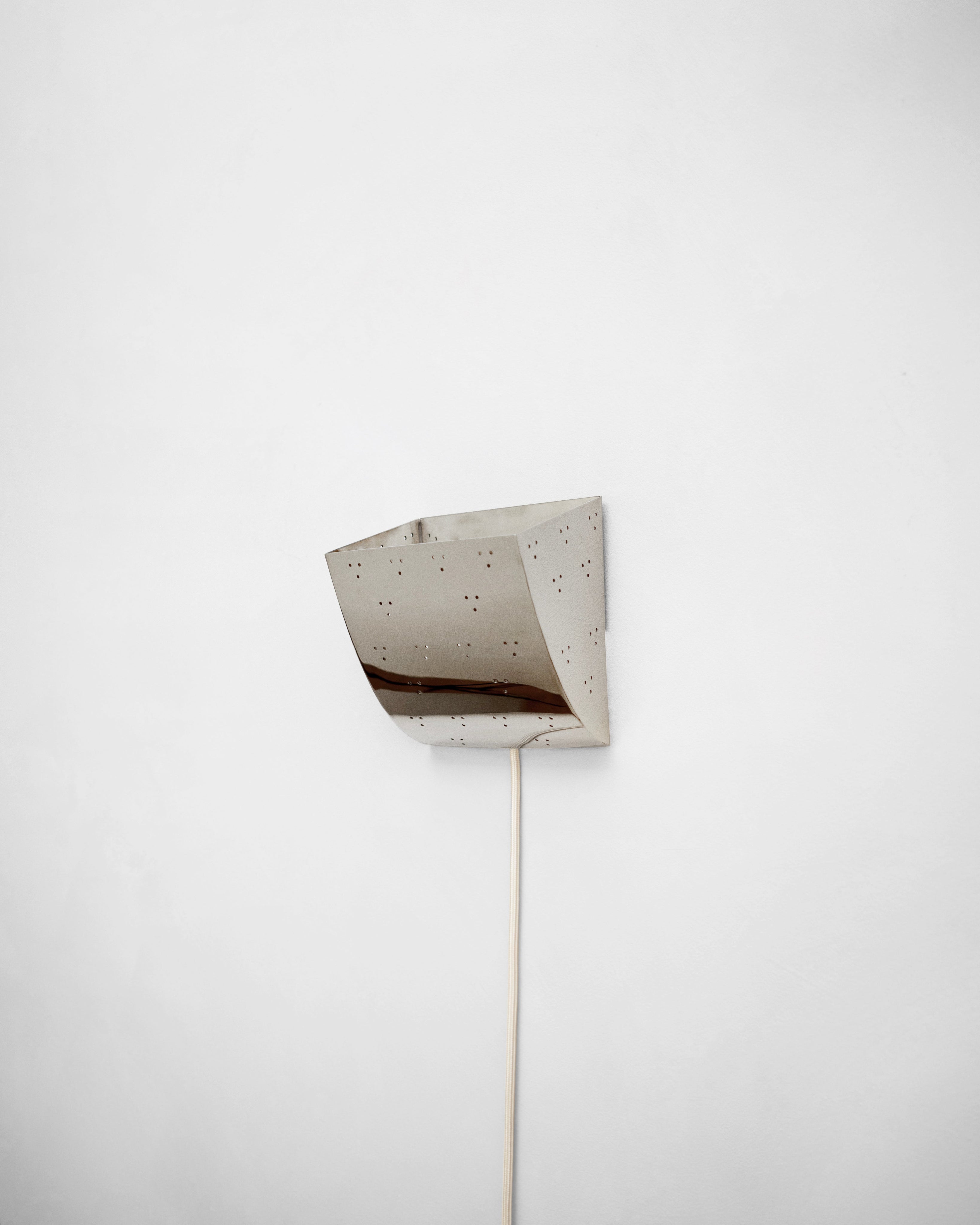 Jolene Wall Lamp - Polished Steel — top view showing reflective surface and cord