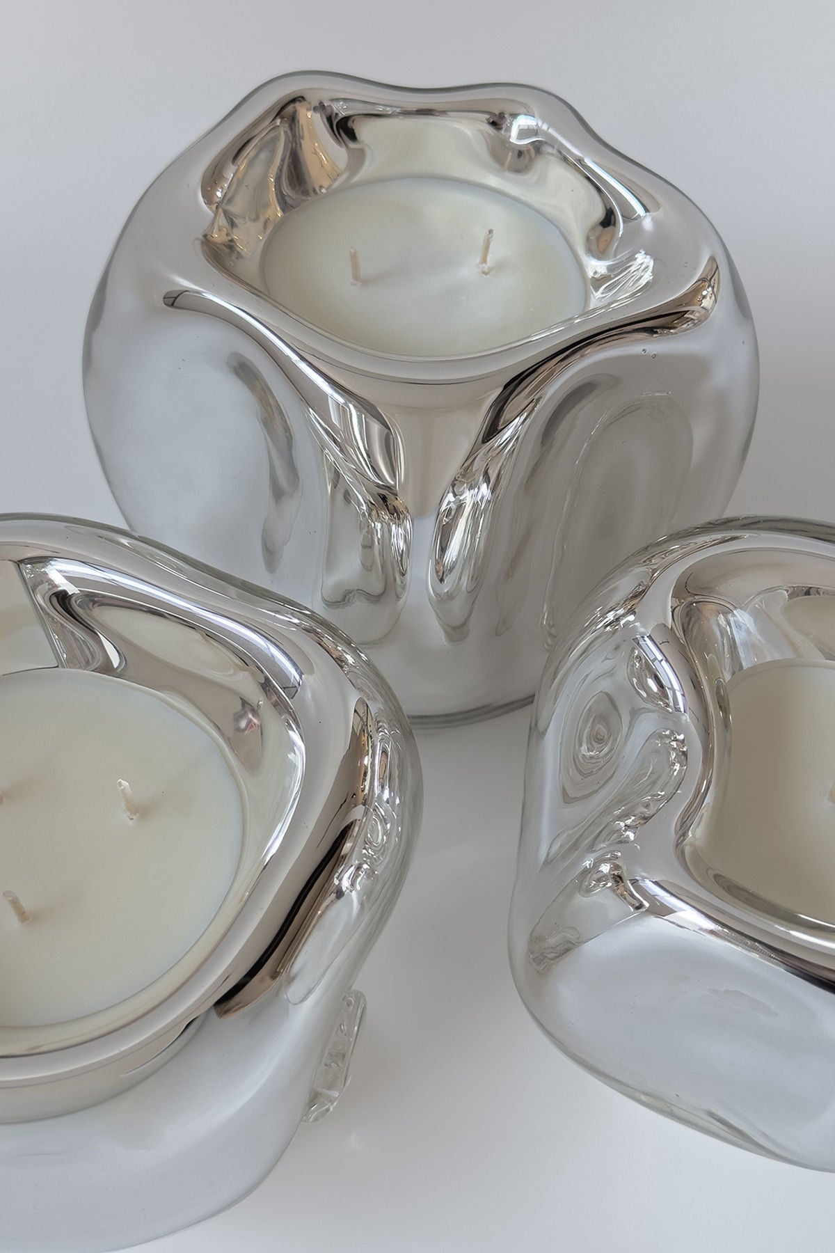 Lumi Candles — back view of shiny silver candle holders