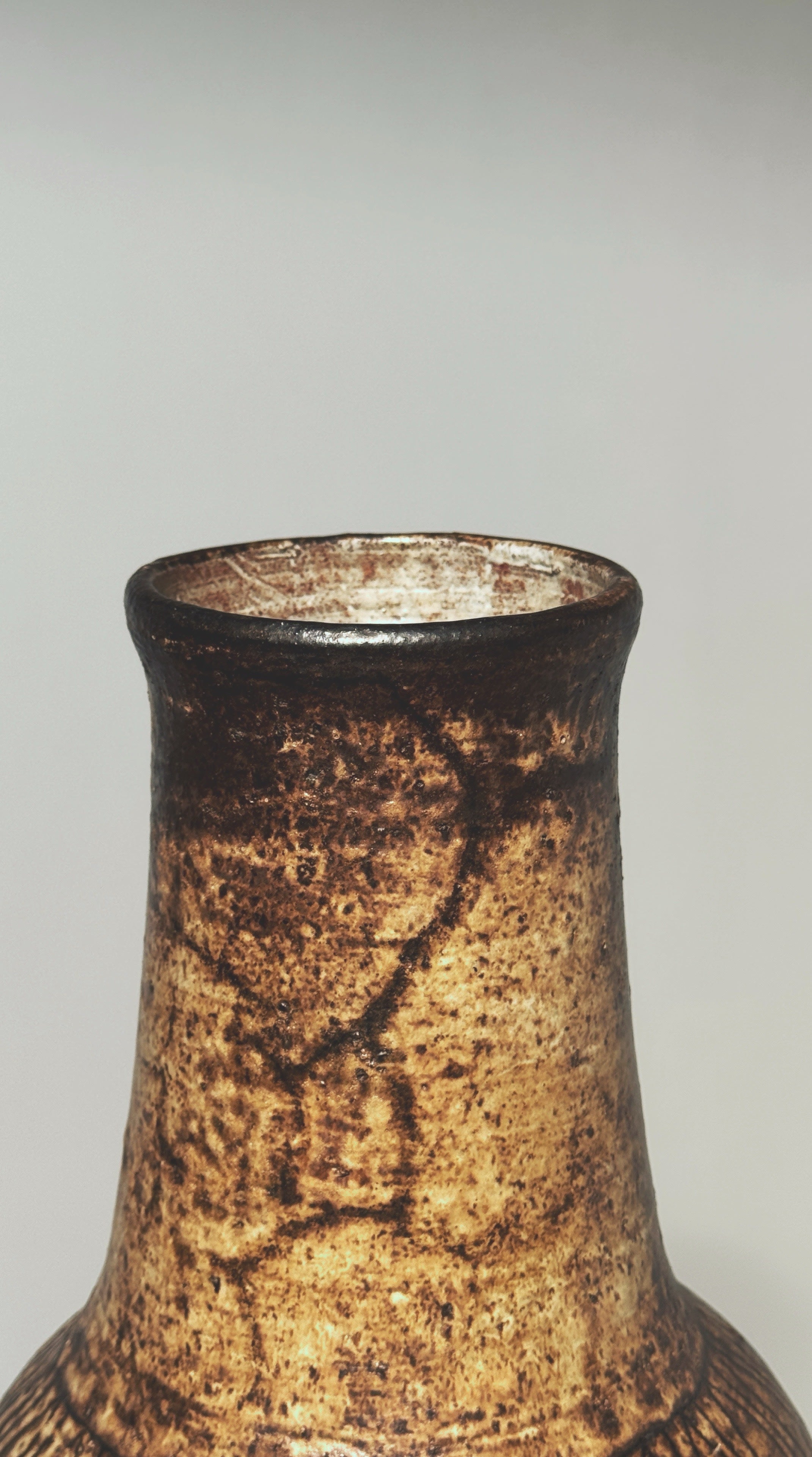 Close-up detail of textured stoneware surface on Pouchain vase