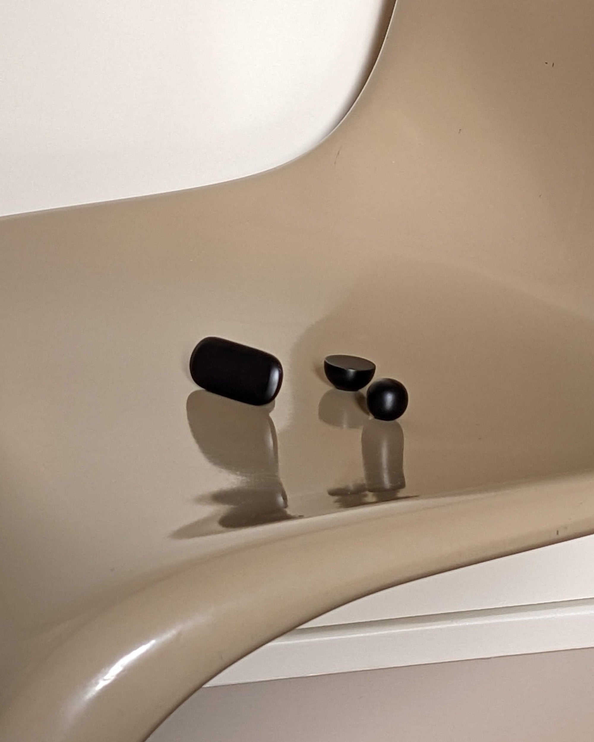 CERCLE Cabinet Knob Small — side view on beige chair surface