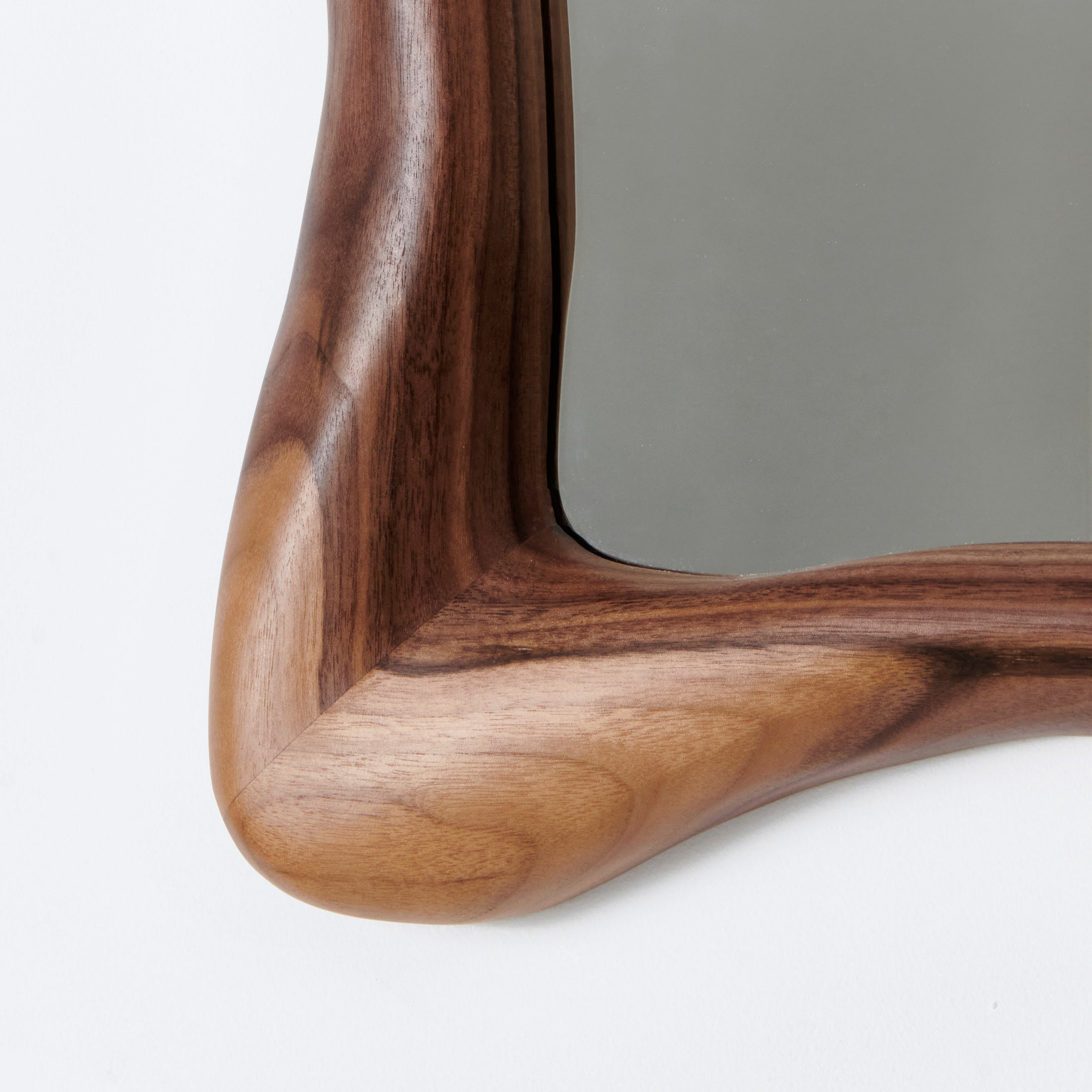 Minho Mirror — close-up of walnut frame corner detail