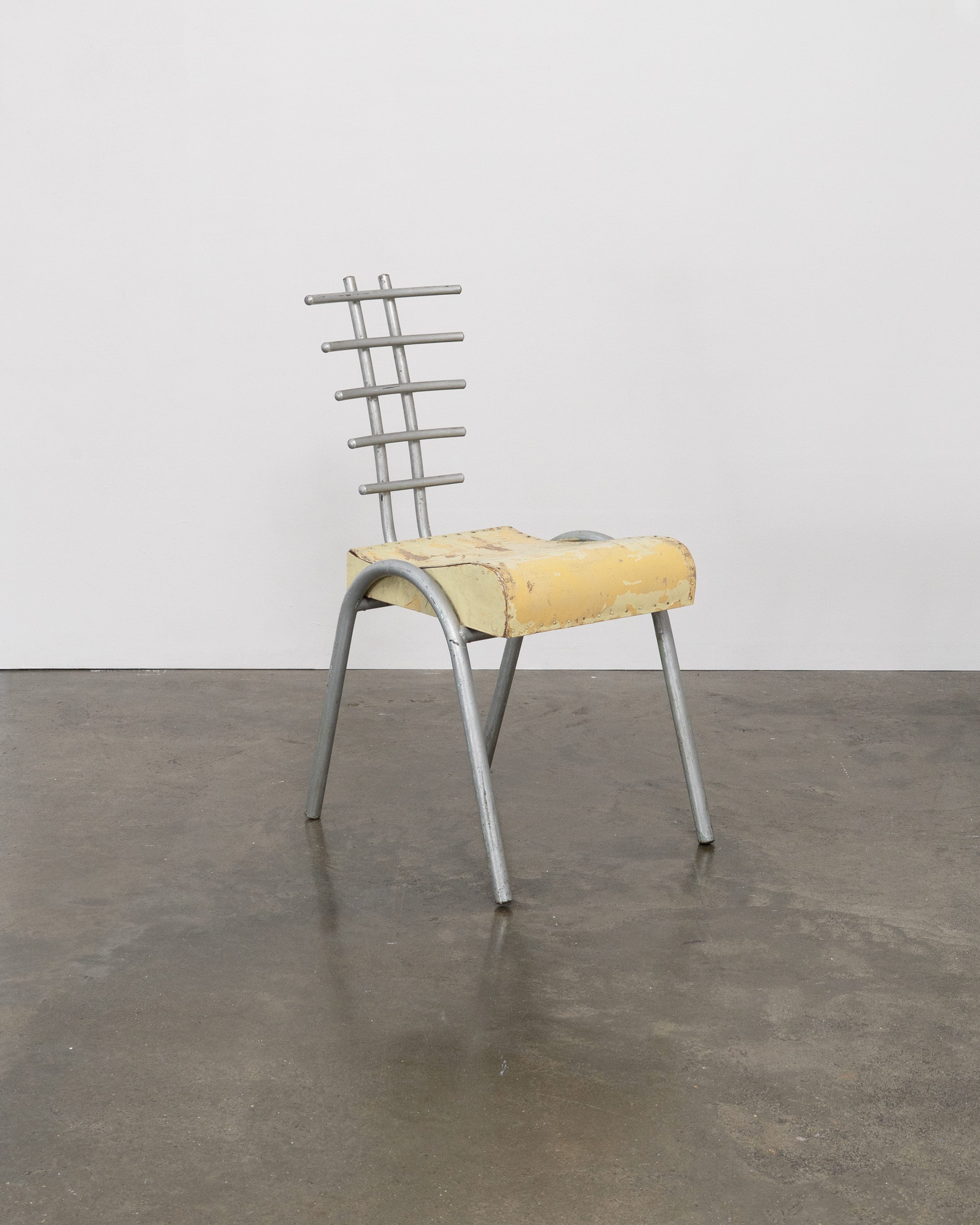 Postmodern prototype chair with yellow foam seat and metal ladder backrest