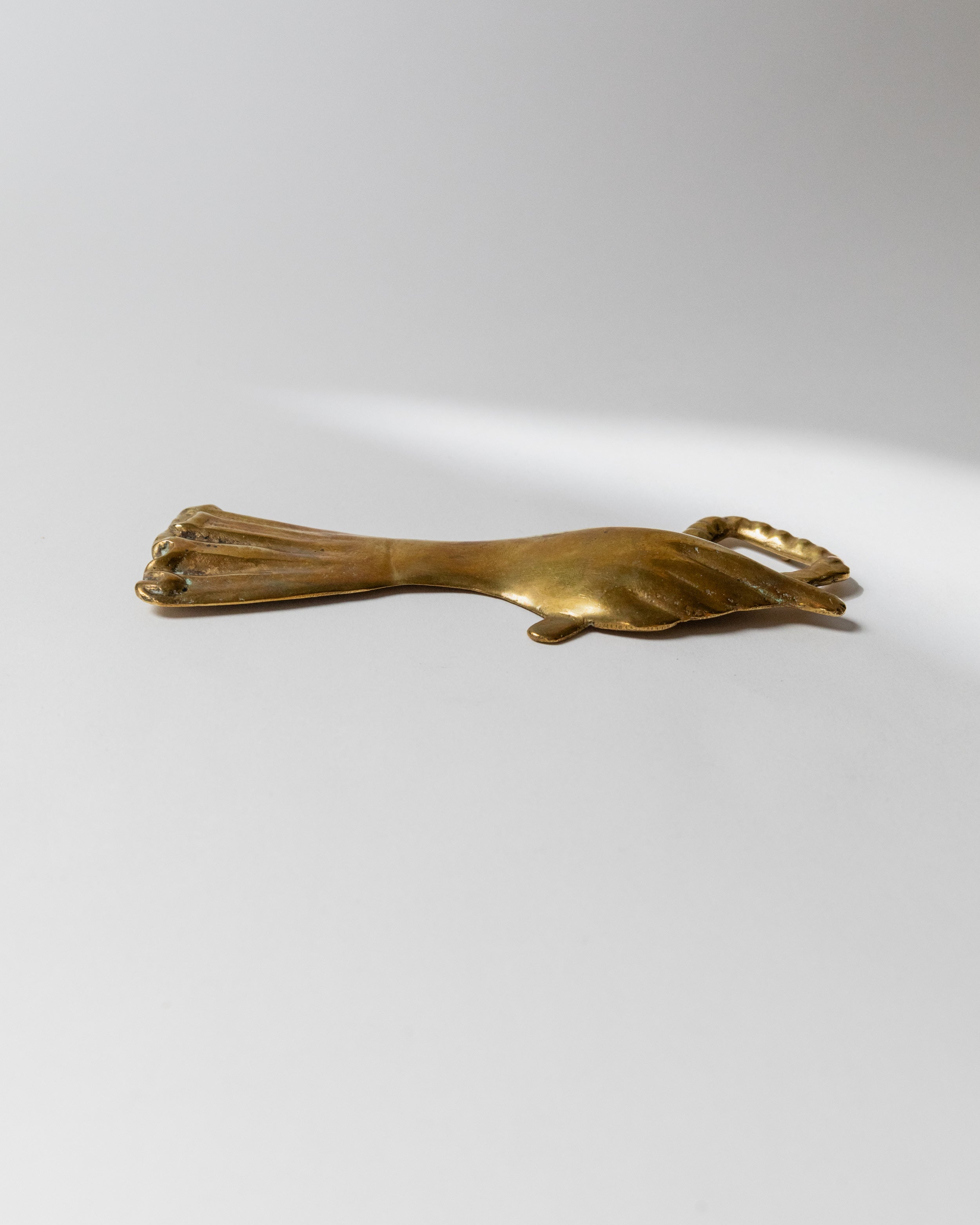 Brass bottle opener hand-shaped design CEG Italy 1950s profile view
