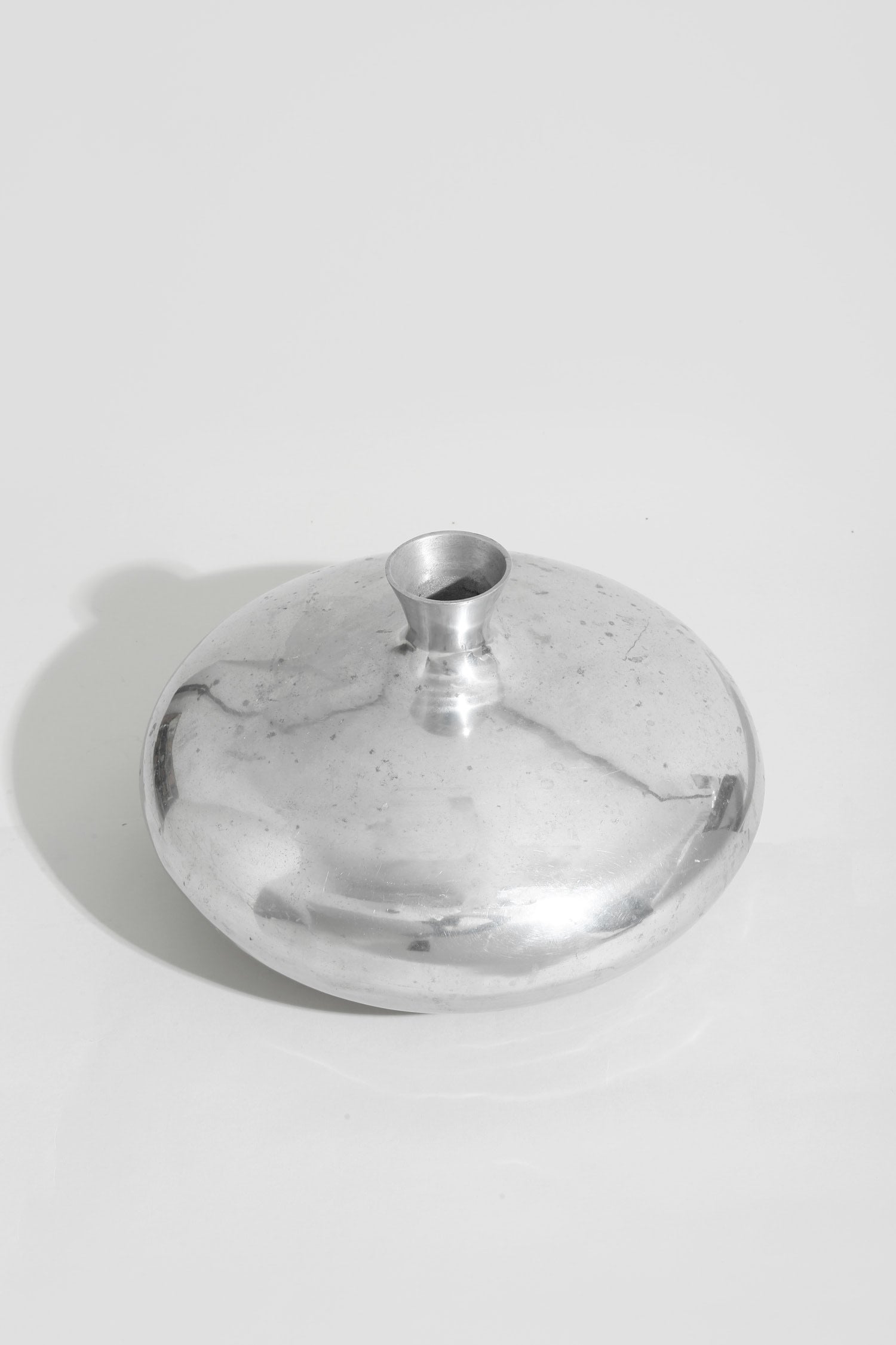 Form Sculpture Vase — side angle showing polished metal surface