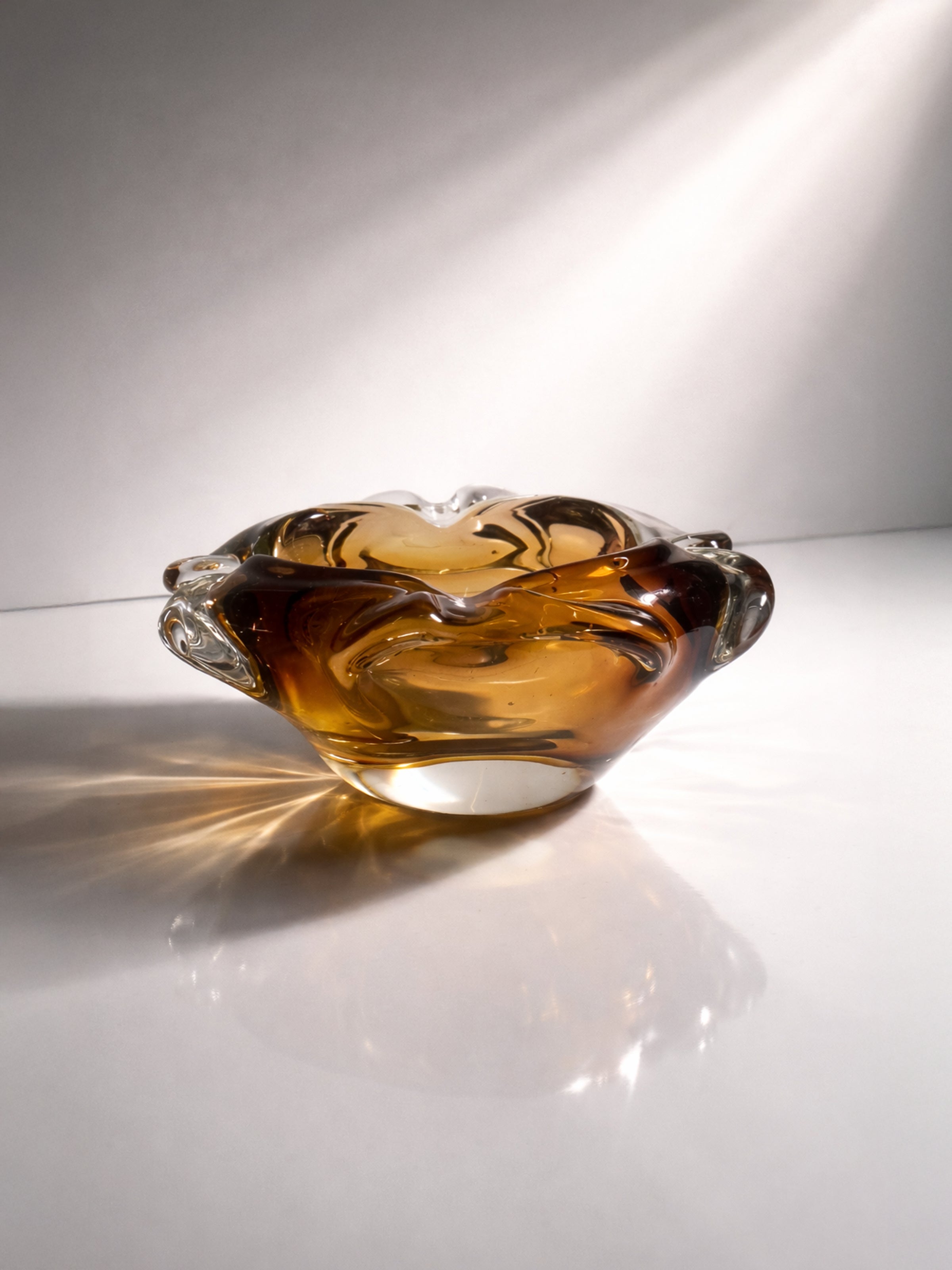 Bohemian Mid Century Ash Tray - 1960s — close-up of amber glass with swirls