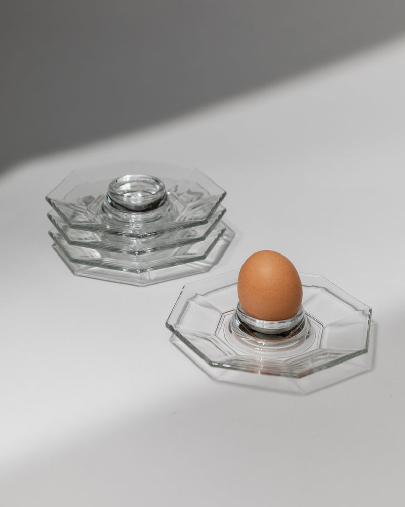 Clear glass hexagonal egg cups set with brown egg, French 1980s design
