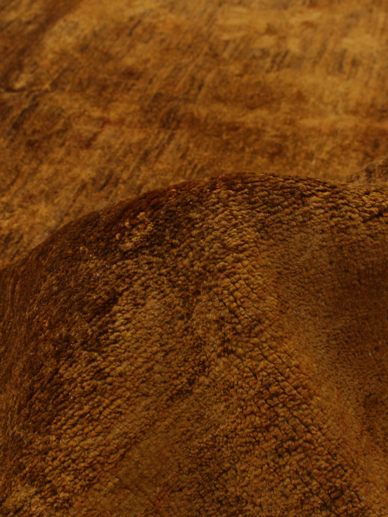 Close-up detail of saffron overdyed rug showing textured weave