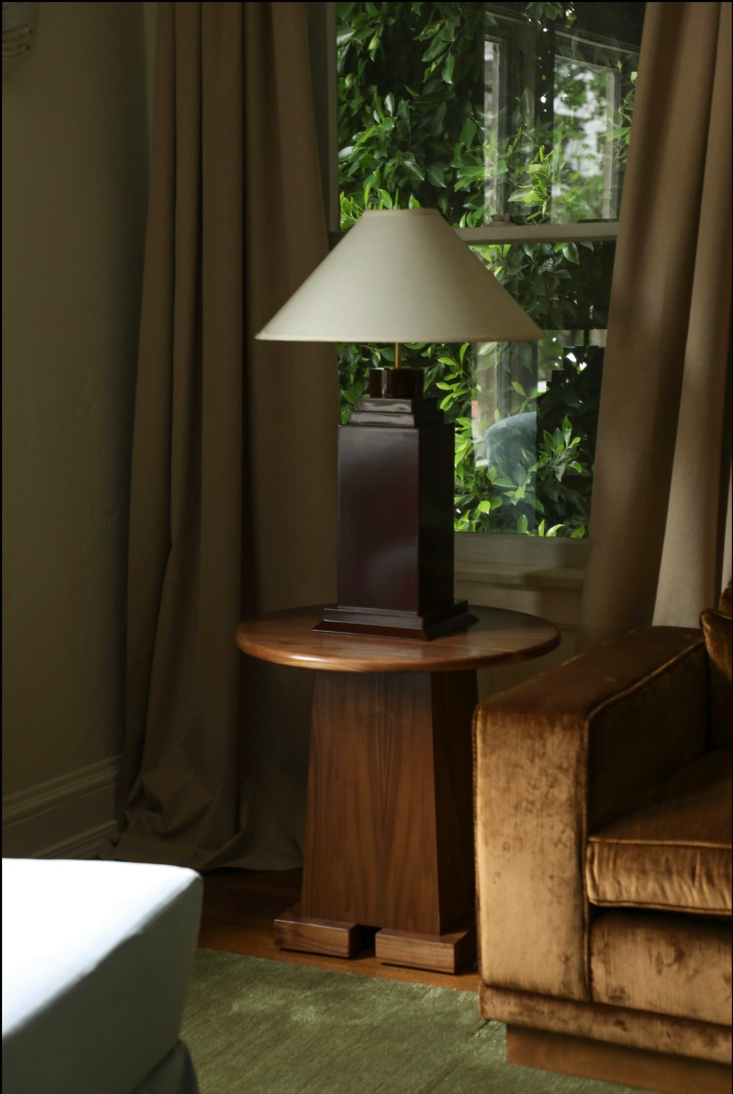 Hudson Table Lamp — side view on wooden side table in living room