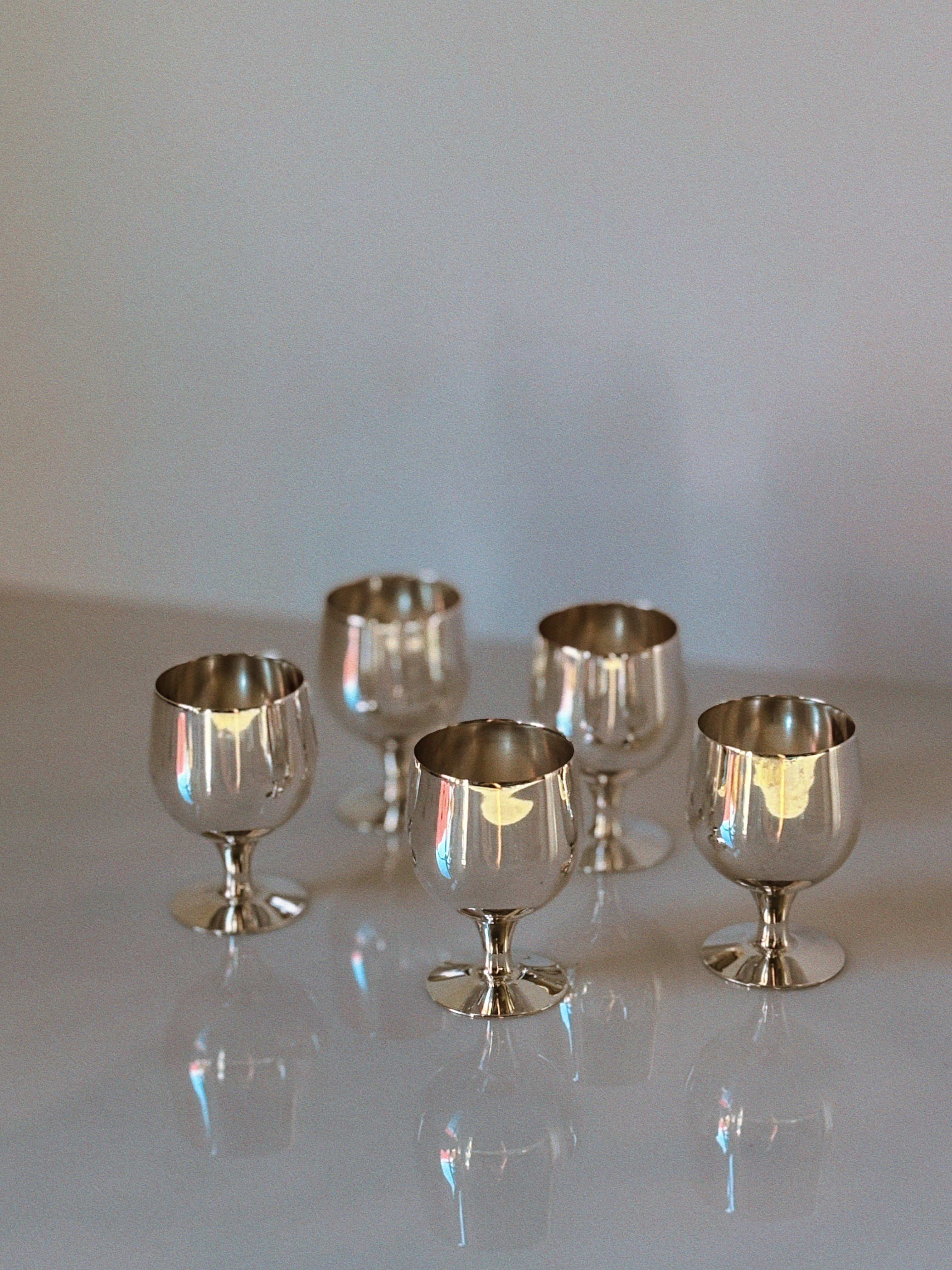 Set of 5 Silver Plated Liquor Cups, 70's Poland — arranged on a reflective surface