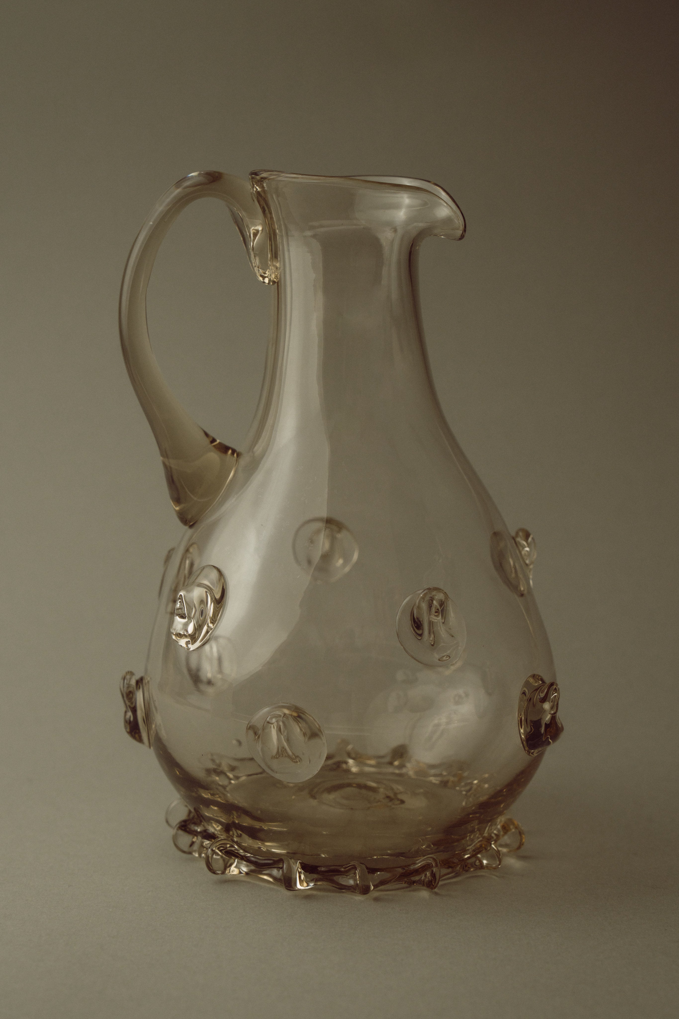Contemporary Carafes in Glass with ornaments - Mouthblown Collection — side view of clear glass carafe with decorative orbs