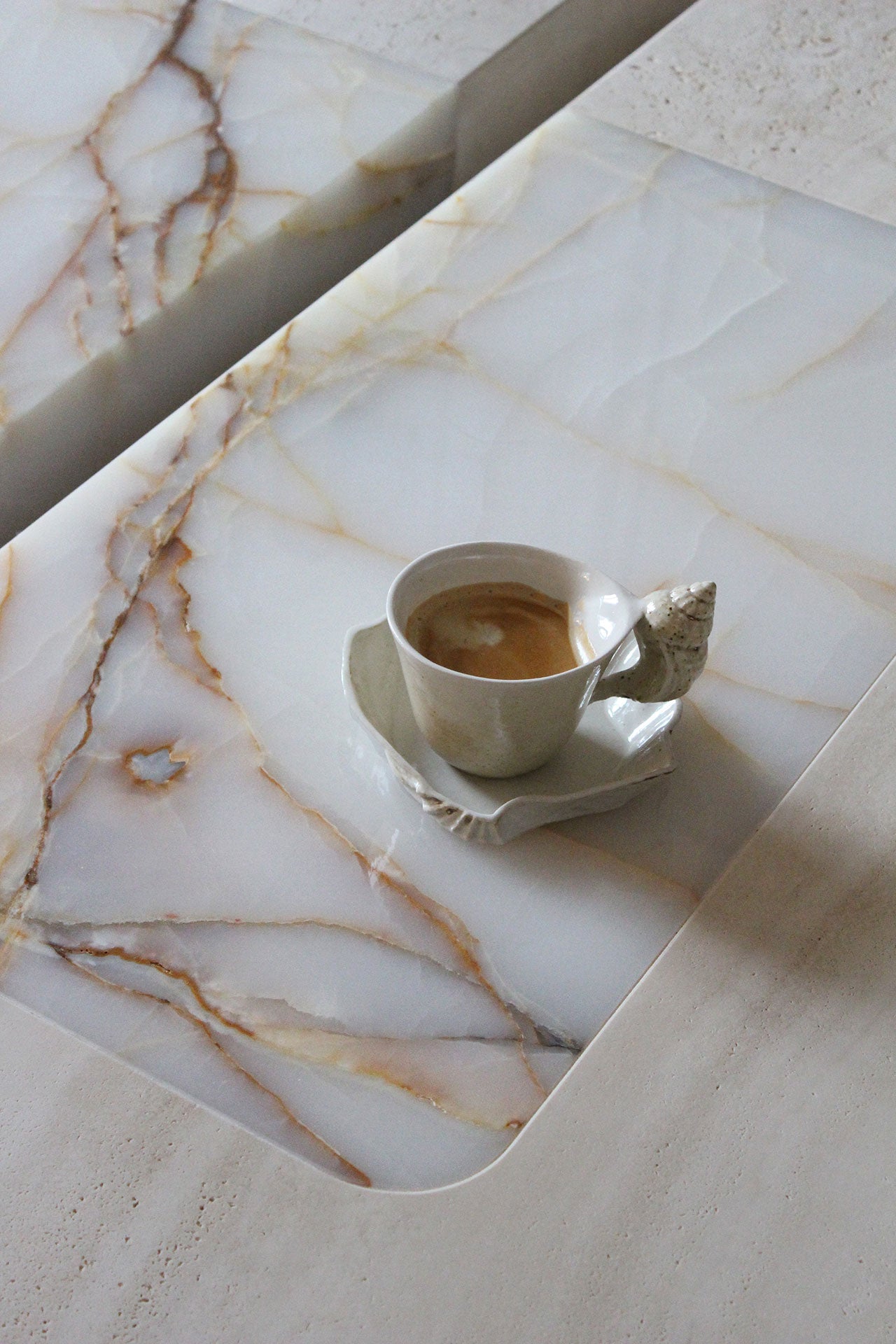 Baci Coffee Table — close-up of marble surface with coffee cup