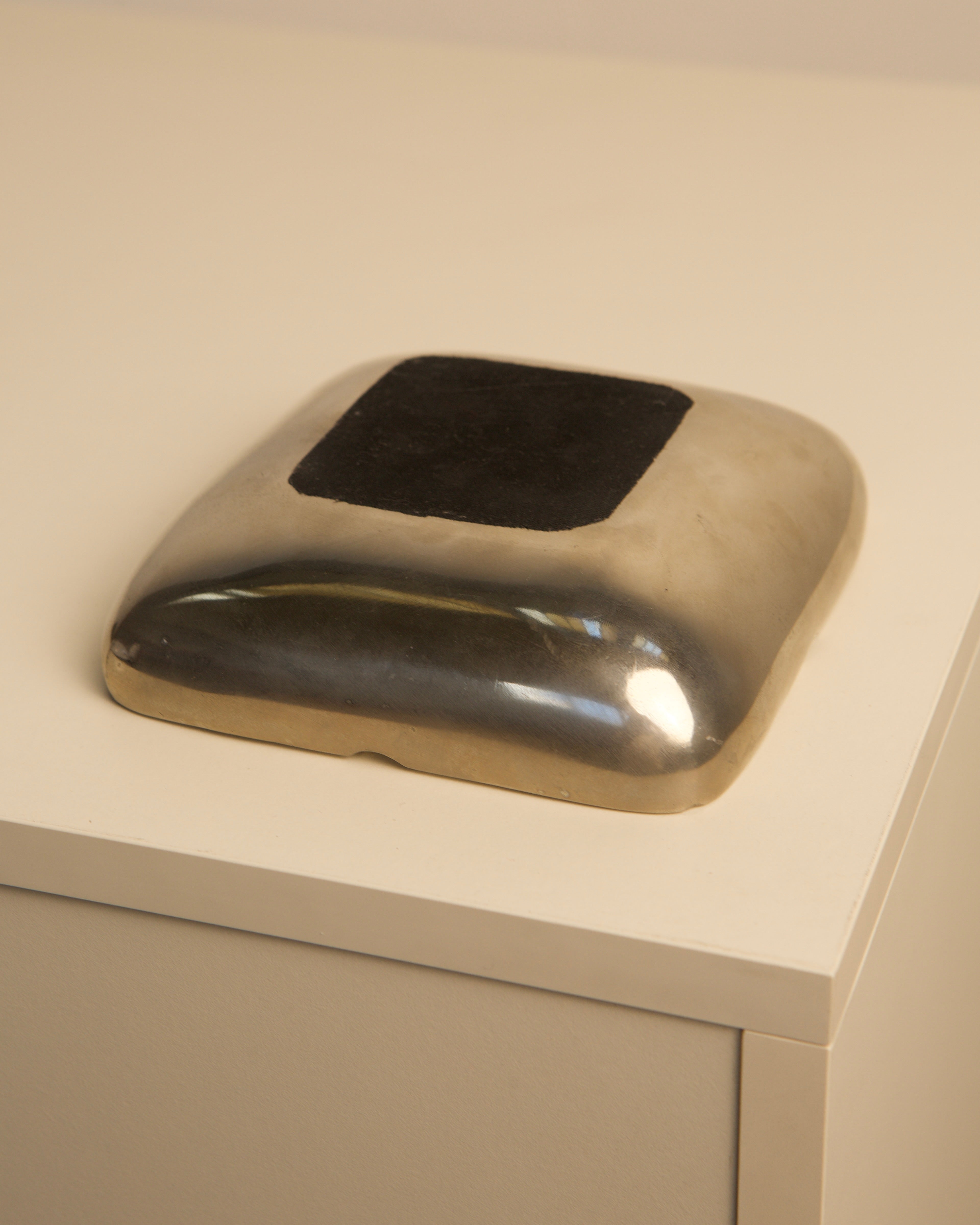 Square aluminum ashtray 1970s showing reflective metallic surface