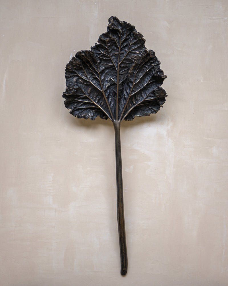 Bronze rhubarb leaf wall light with detailed veining and stem